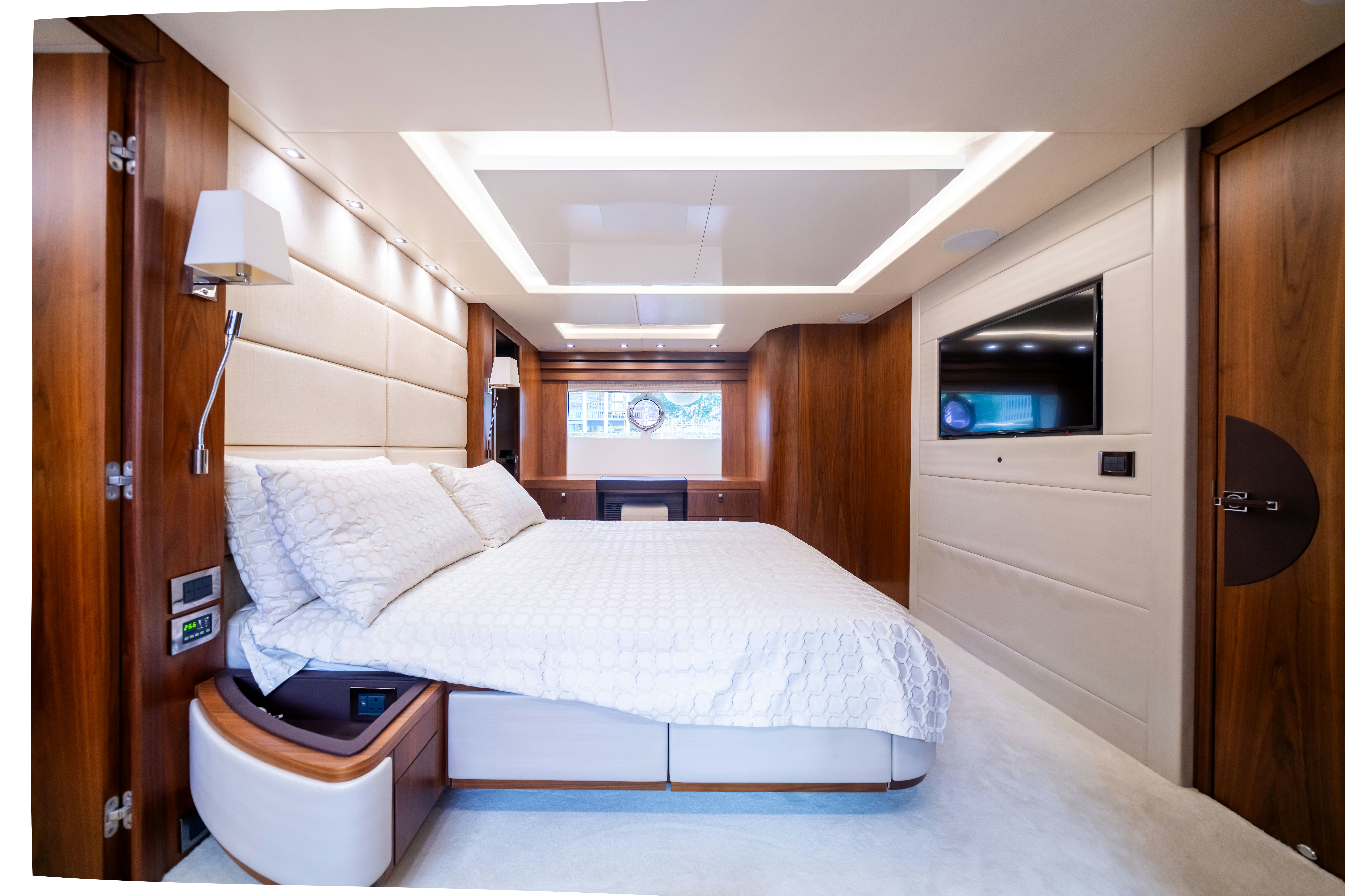 a bedroom with a bed and a television aboard DRAGON Yacht for Sale