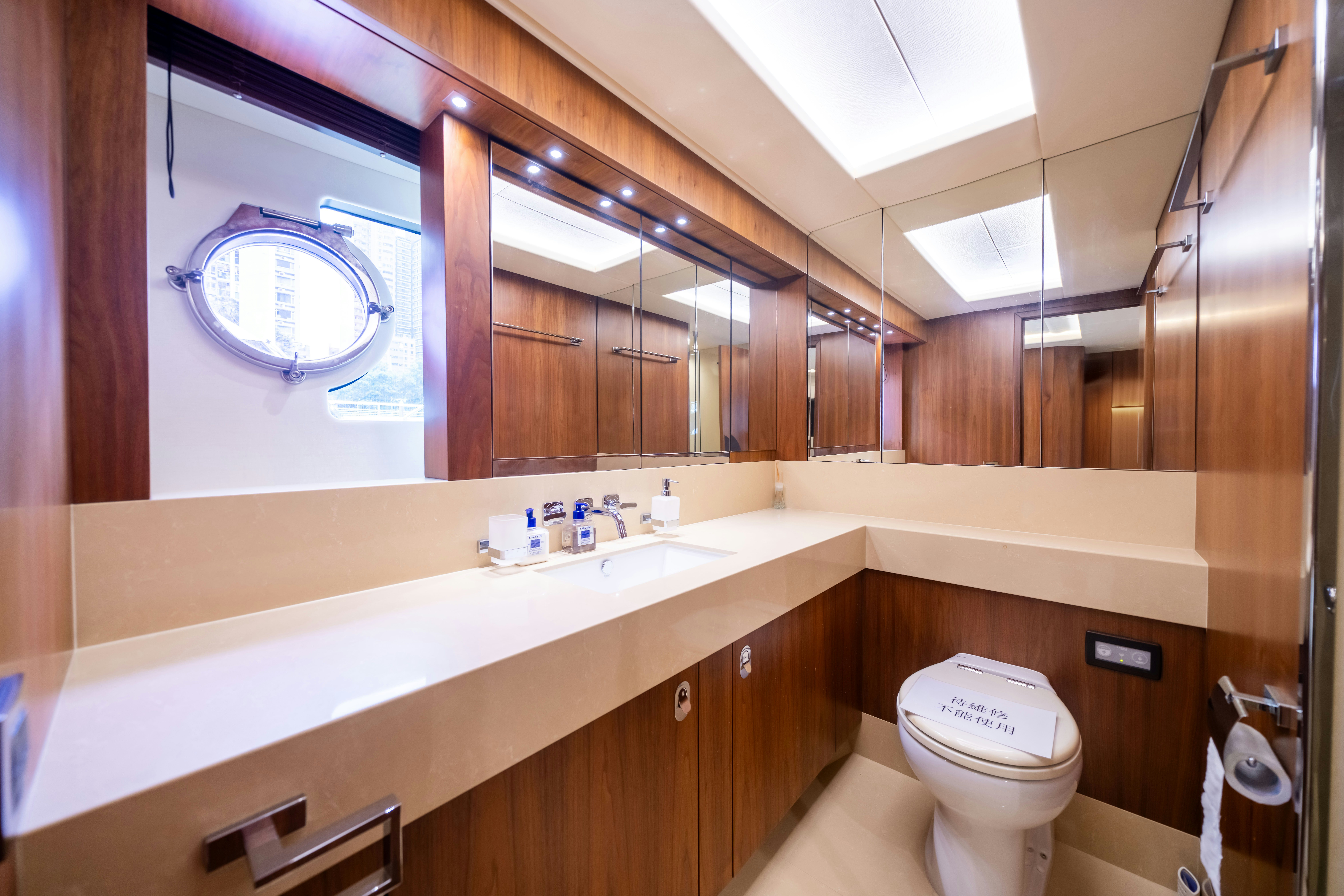 a bathroom with a large mirror aboard DRAGON Yacht for Sale