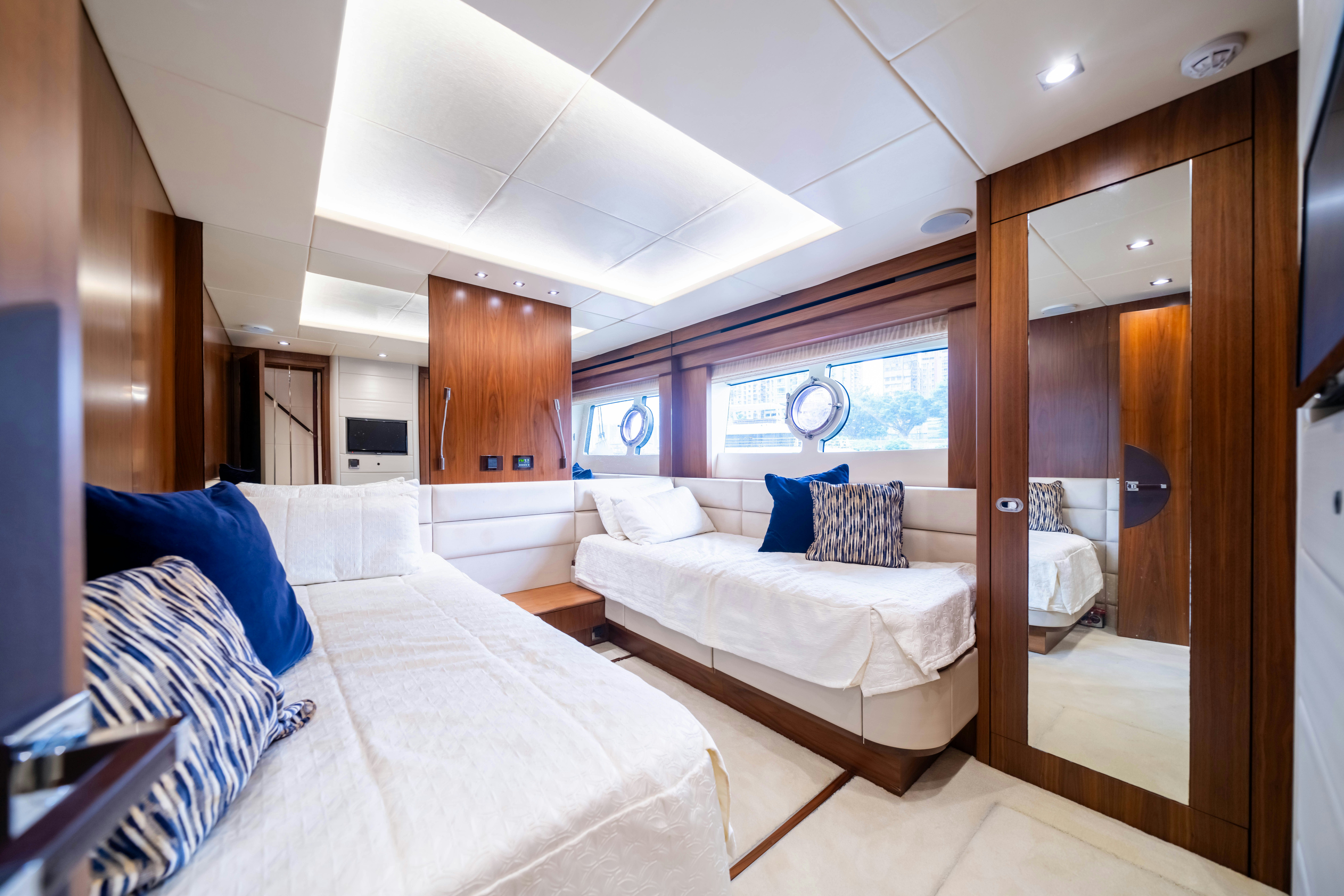 a room with a bed and a mirror aboard DRAGON Yacht for Sale