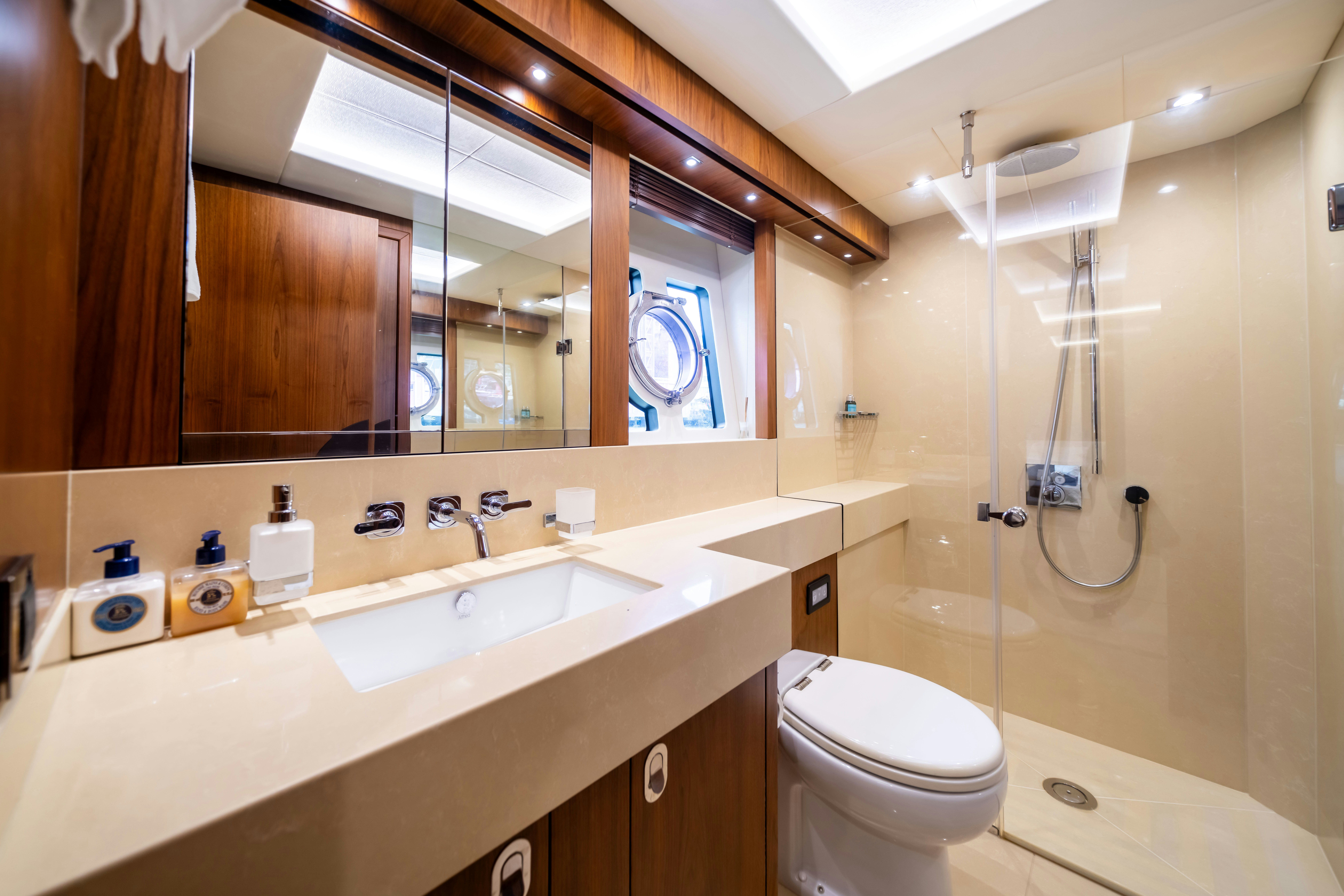 a bathroom with a large mirror aboard DRAGON Yacht for Sale