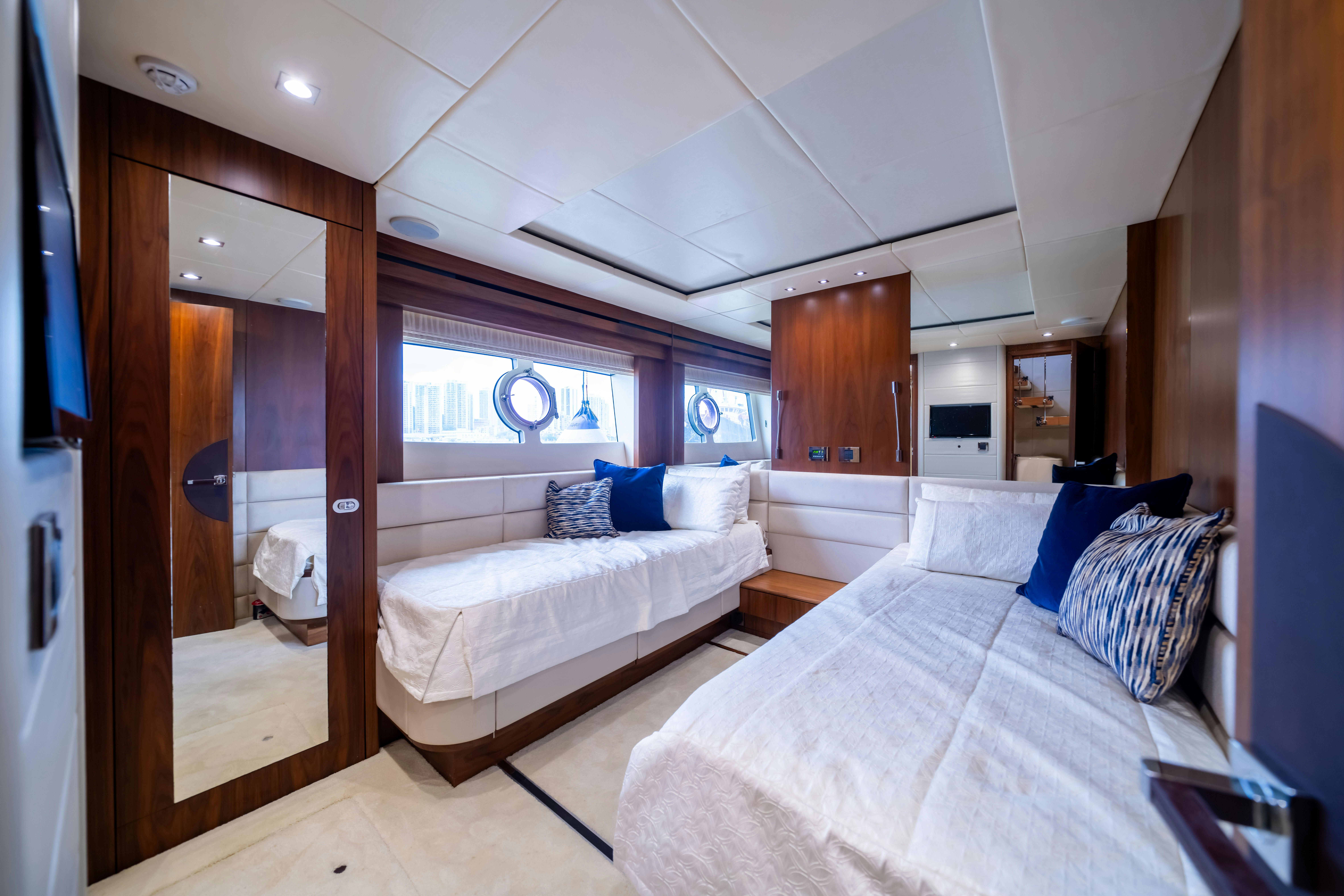 a room with a bed and a mirror aboard DRAGON Yacht for Sale