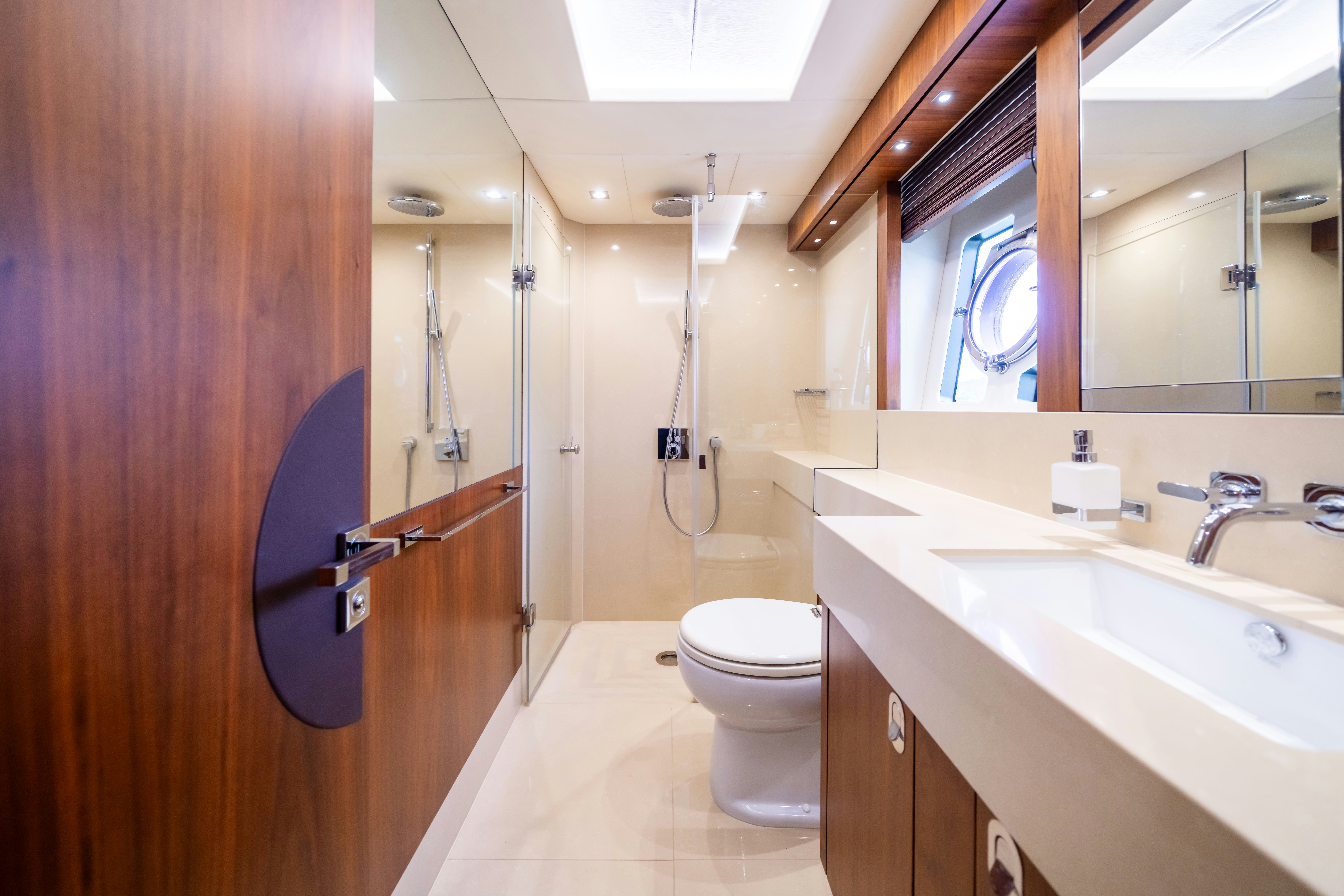 a bathroom with a sink toilet and a mirror aboard DRAGON Yacht for Sale