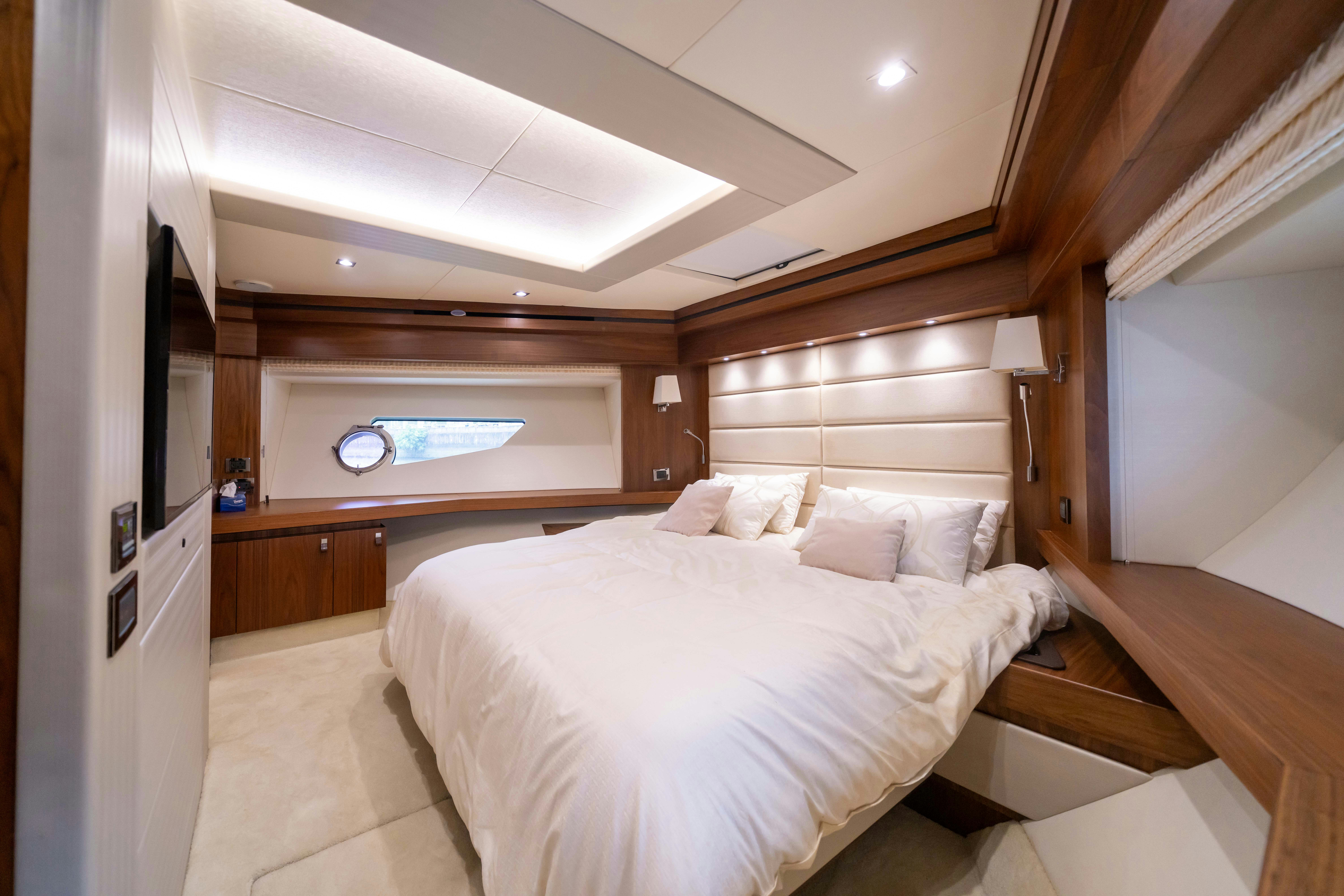a room with a bed and a desk aboard DRAGON Yacht for Sale