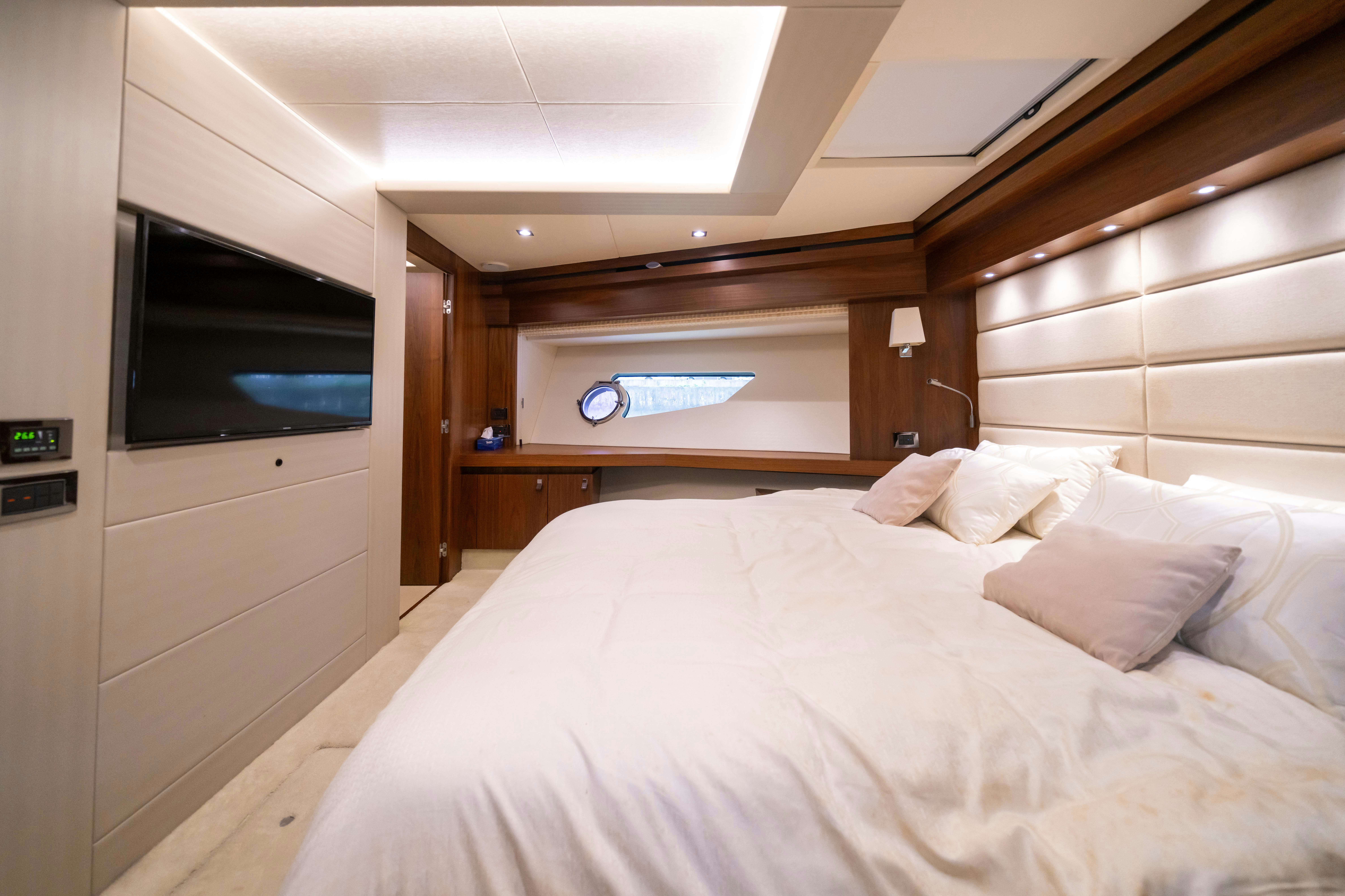 a bed with white sheets aboard DRAGON Yacht for Sale
