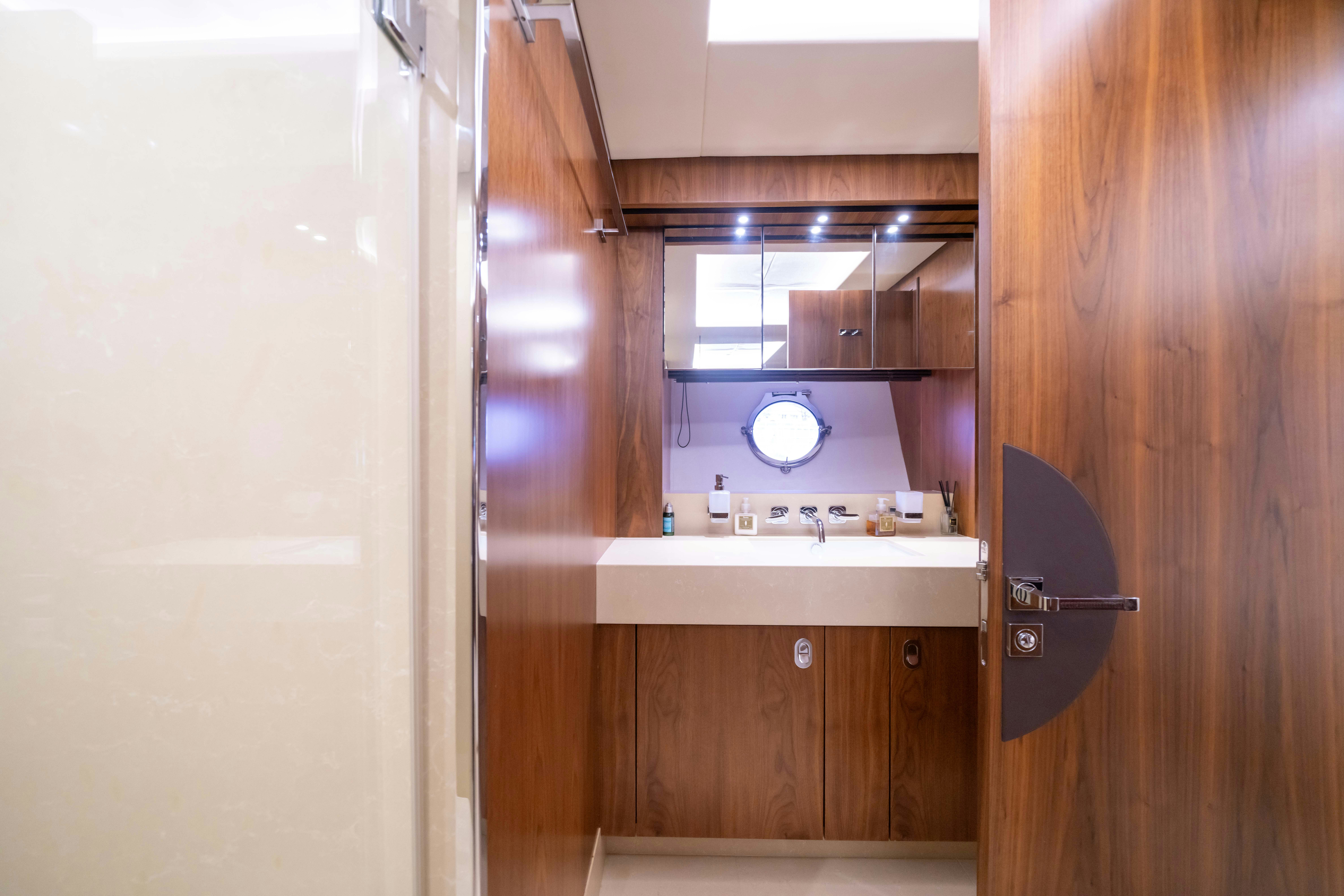 a bathroom with a sink and cabinets aboard DRAGON Yacht for Sale