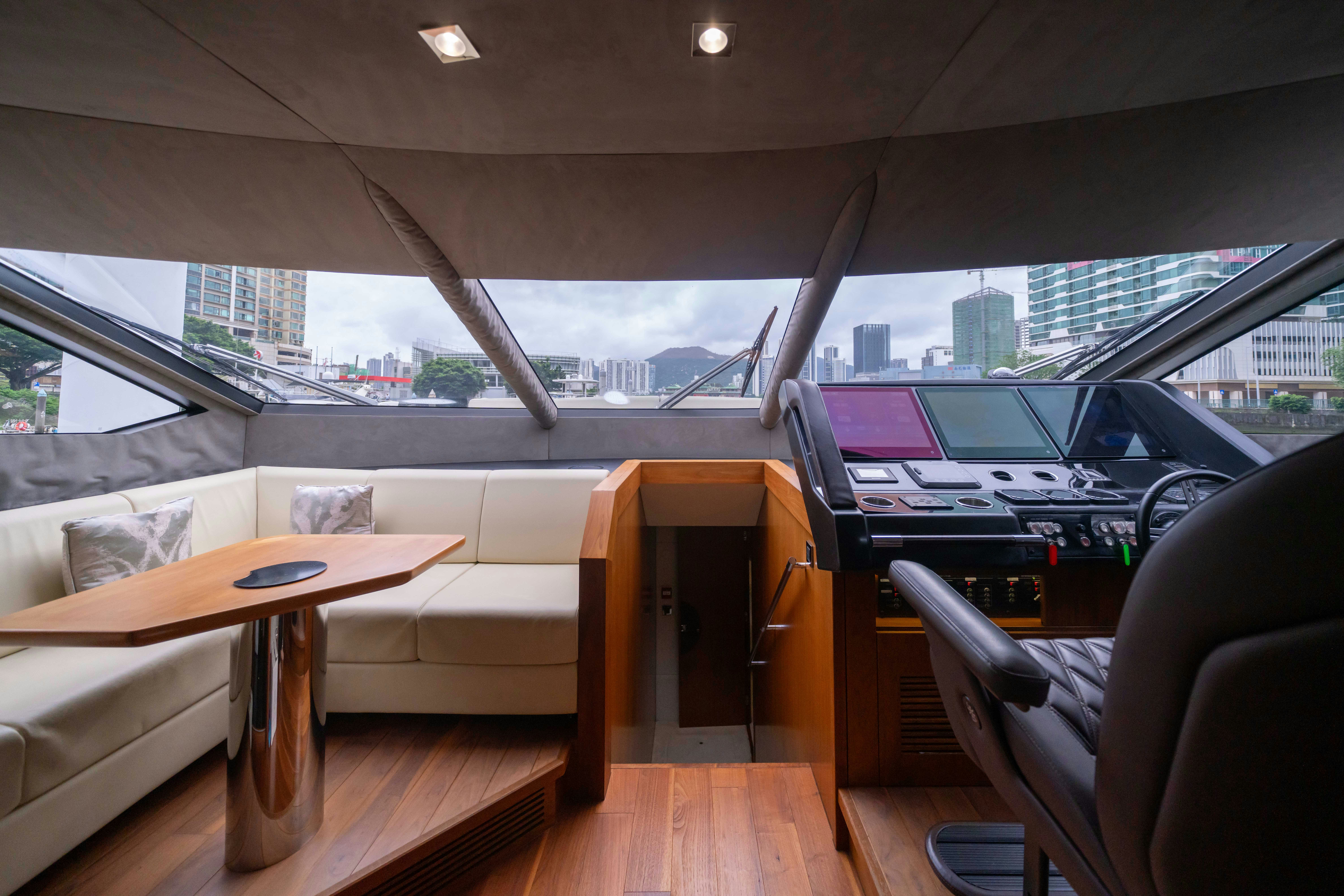 a room with a couch and a table and a window aboard DRAGON Yacht for Sale