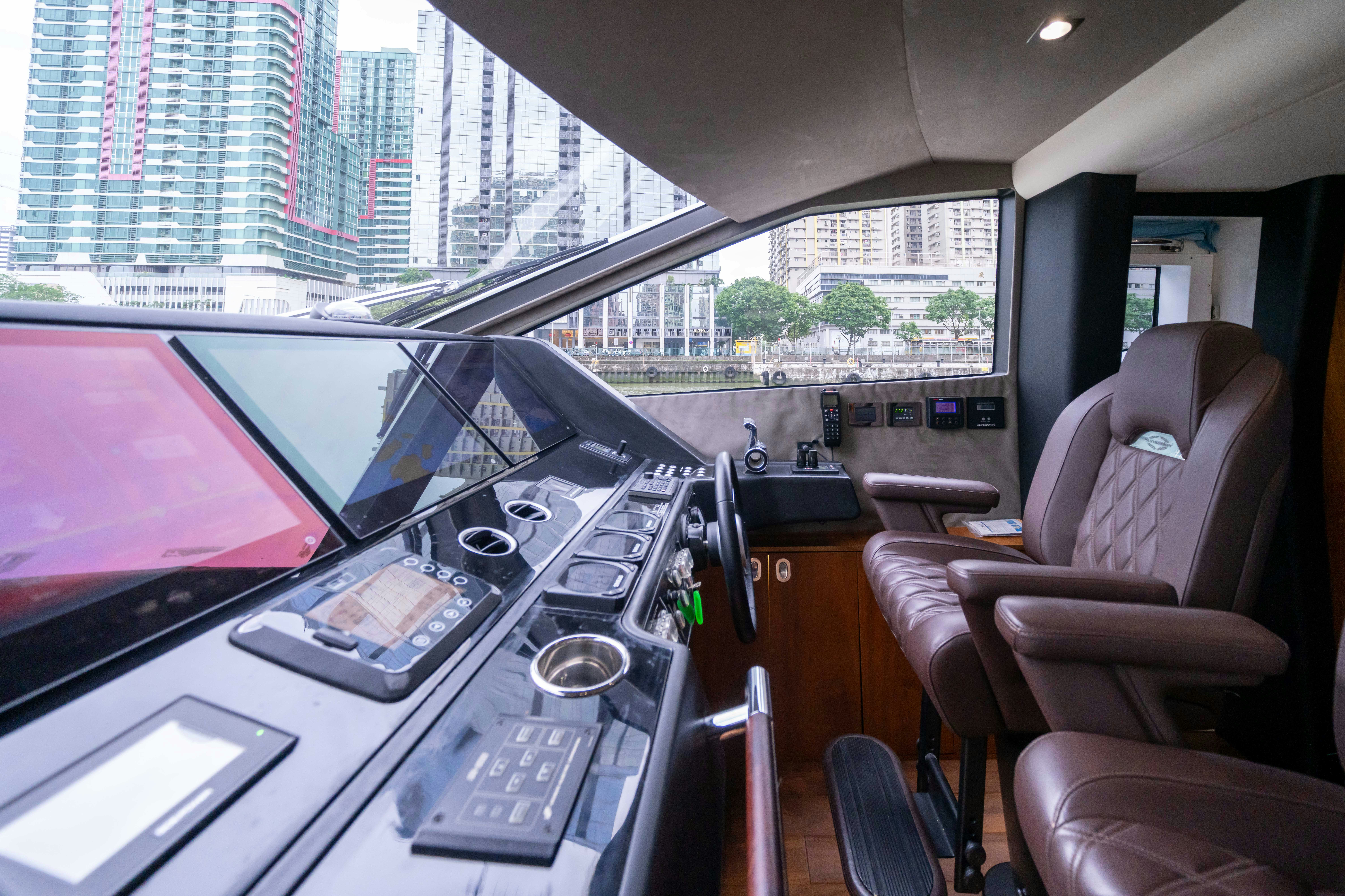inside of a vehicle with a screen and a laptop on the dashboard aboard DRAGON Yacht for Sale