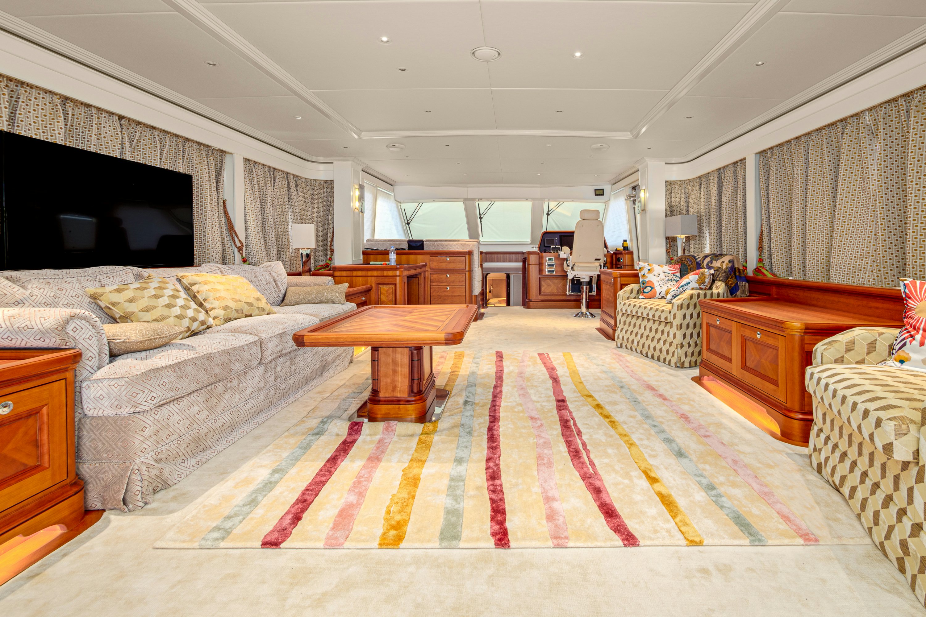 a living room with a large rug aboard FRIVOLOUS Yacht for Sale