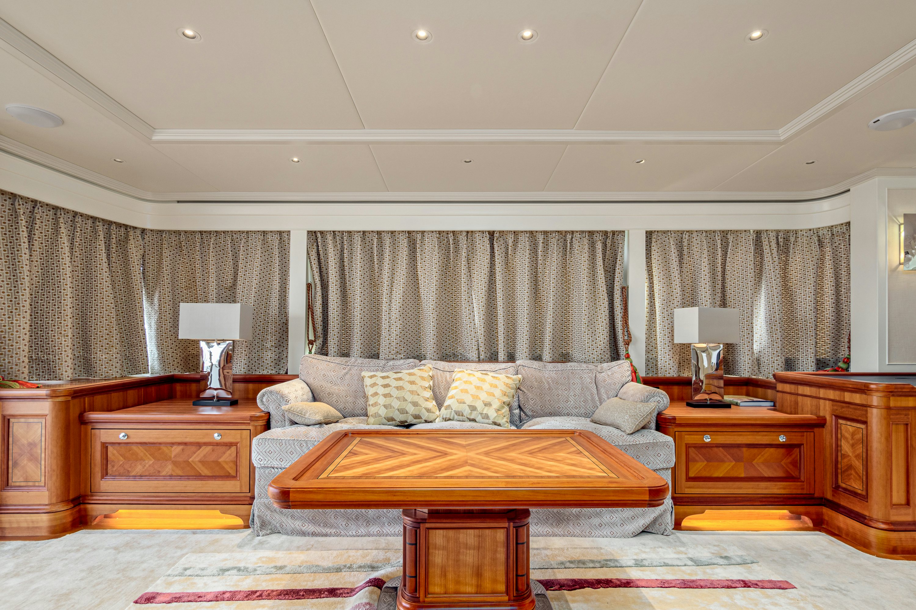 a living room with a couch and a table aboard FRIVOLOUS Yacht for Sale