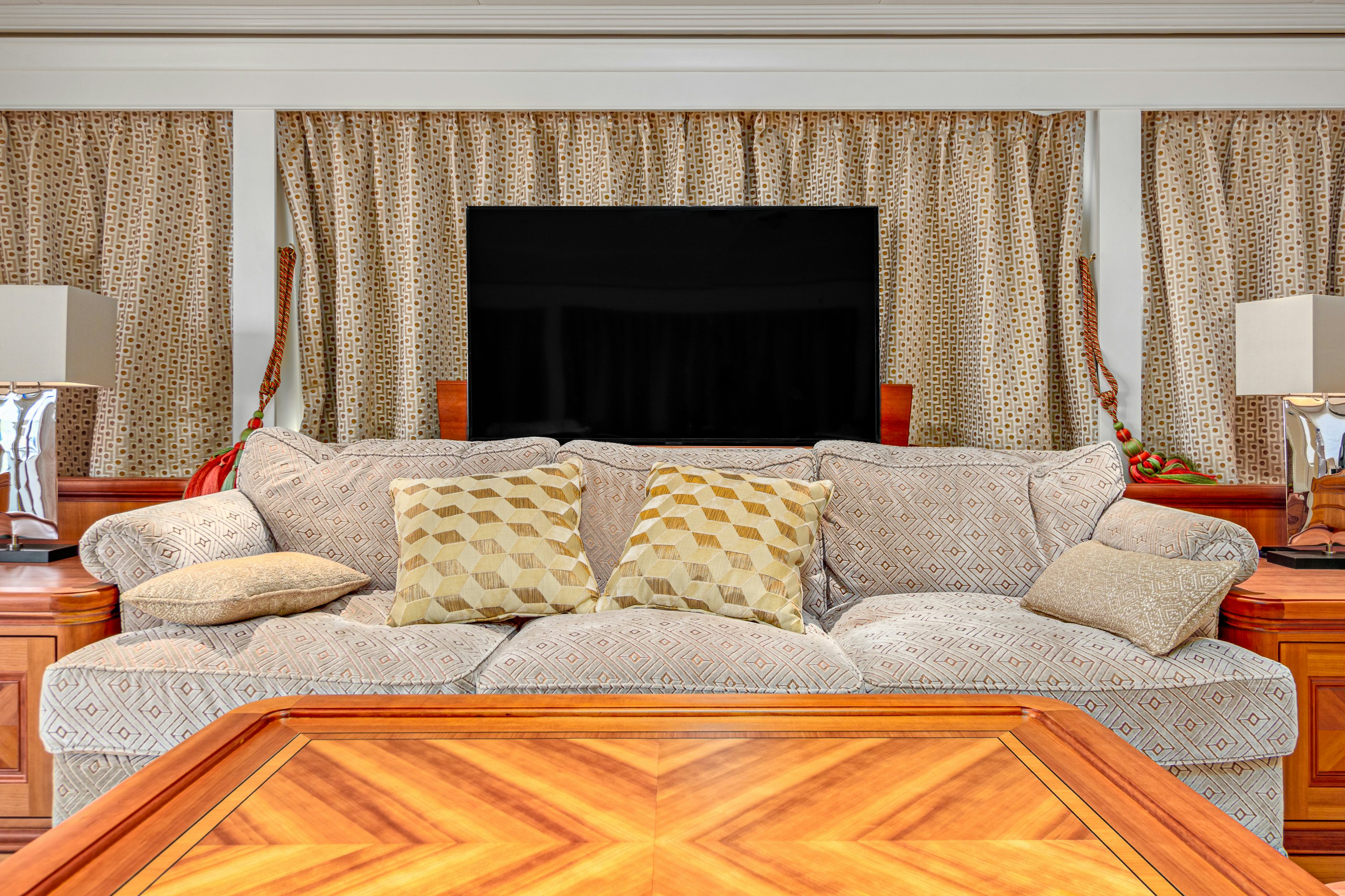 a large white couch with pillows aboard FRIVOLOUS Yacht for Sale