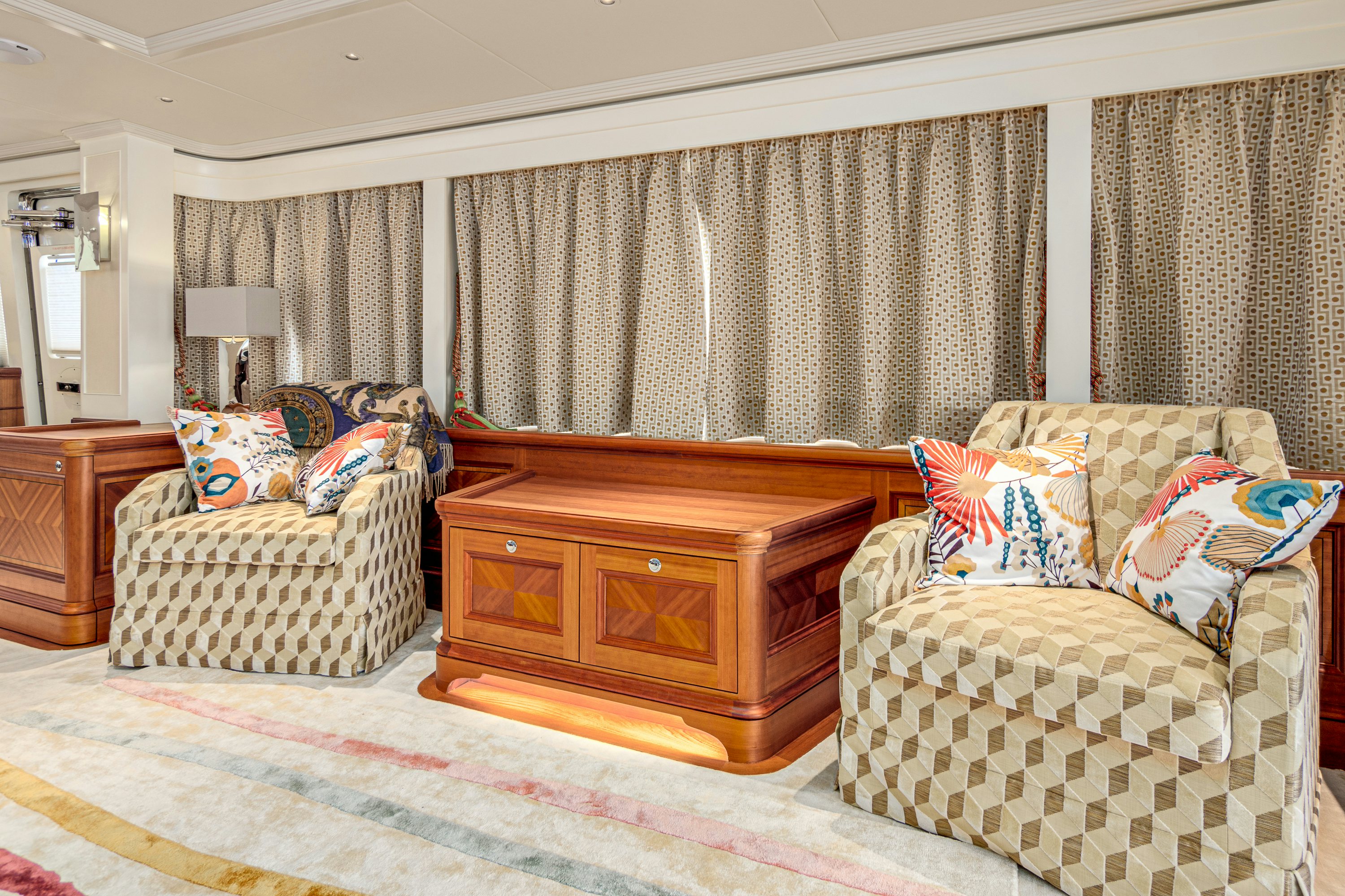 a living room with a fireplace aboard FRIVOLOUS Yacht for Sale