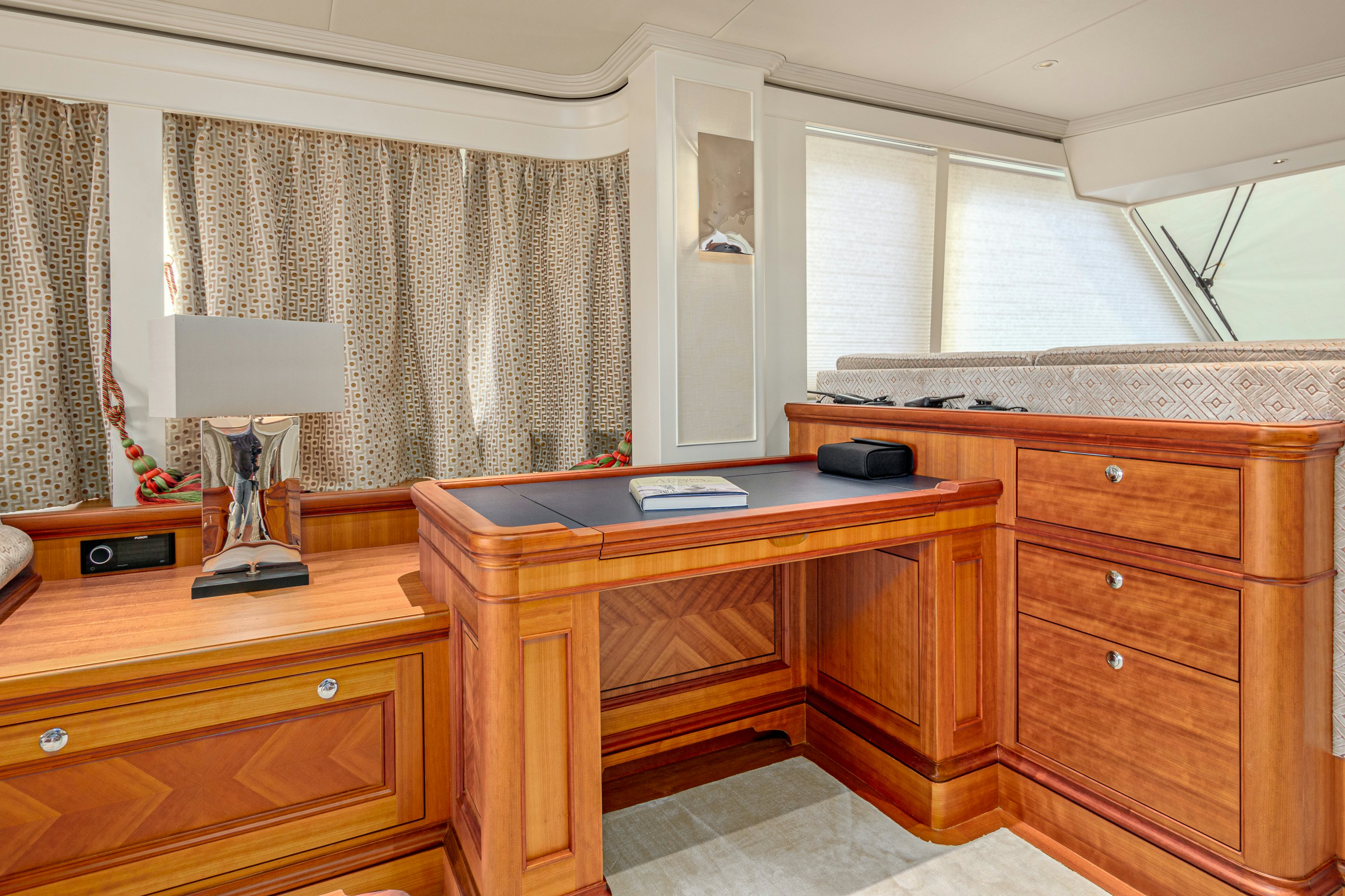 a room with a desk and a lamp aboard FRIVOLOUS Yacht for Sale