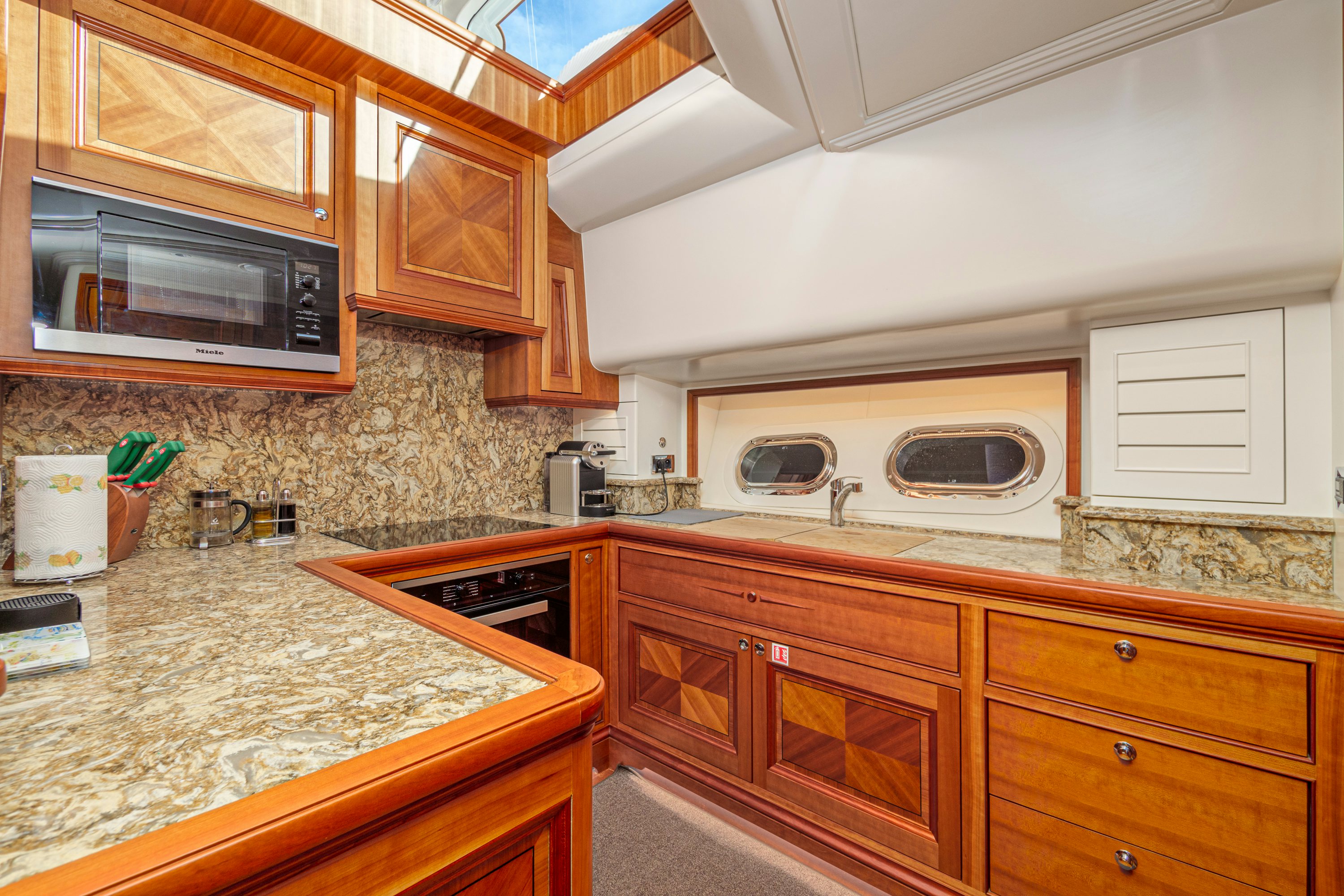 a kitchen with a microwave oven aboard FRIVOLOUS Yacht for Sale