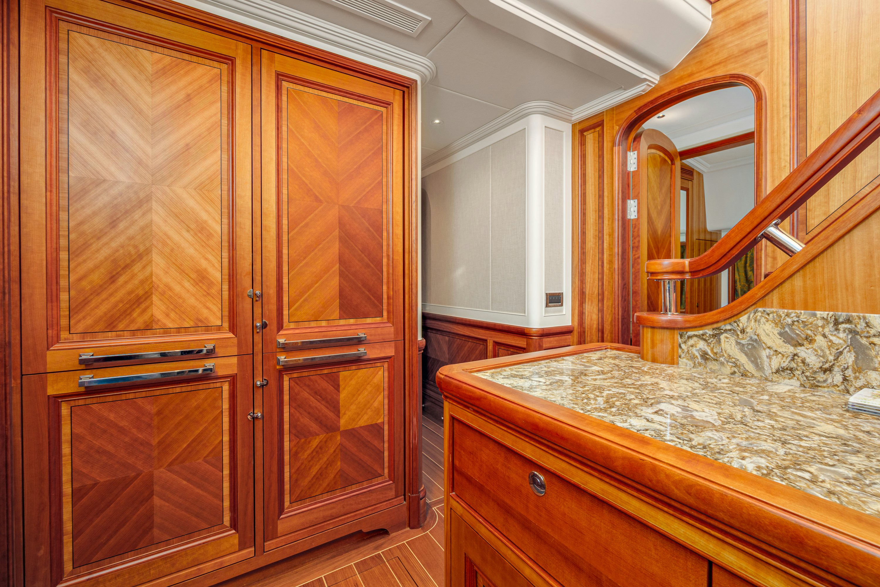 a bathroom with wooden cabinets aboard FRIVOLOUS Yacht for Sale