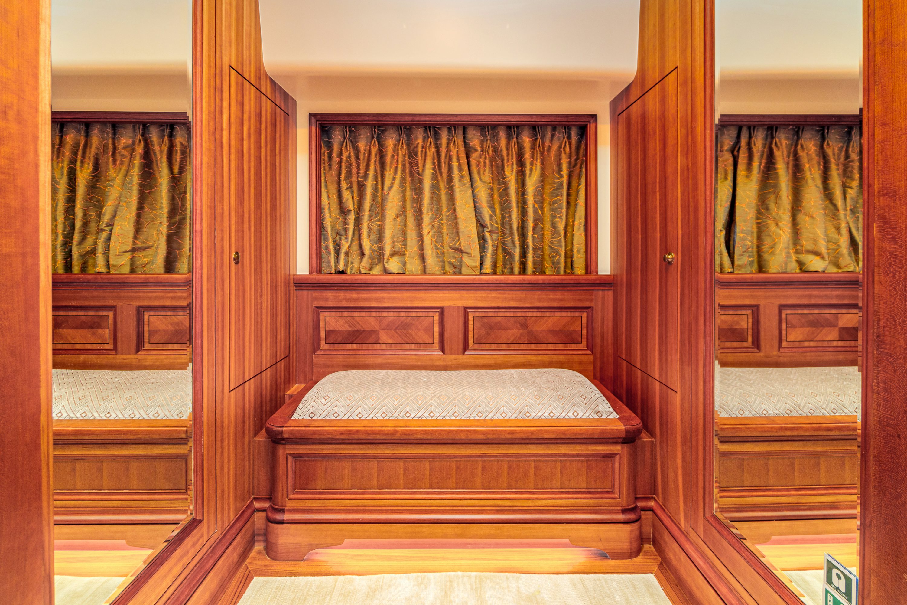 a room with a bed and a window aboard FRIVOLOUS Yacht for Sale