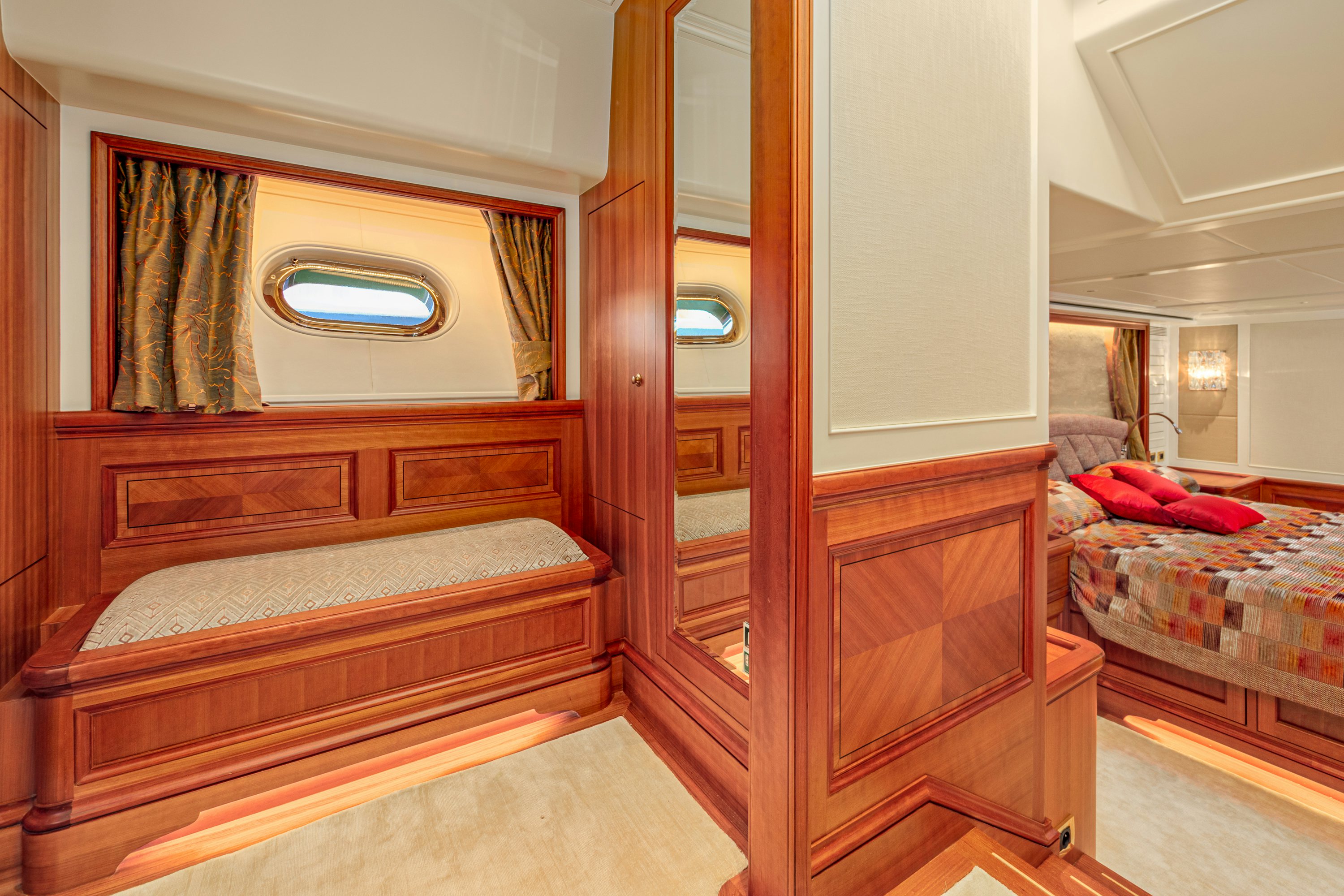 a room with a bed and a mirror aboard FRIVOLOUS Yacht for Sale