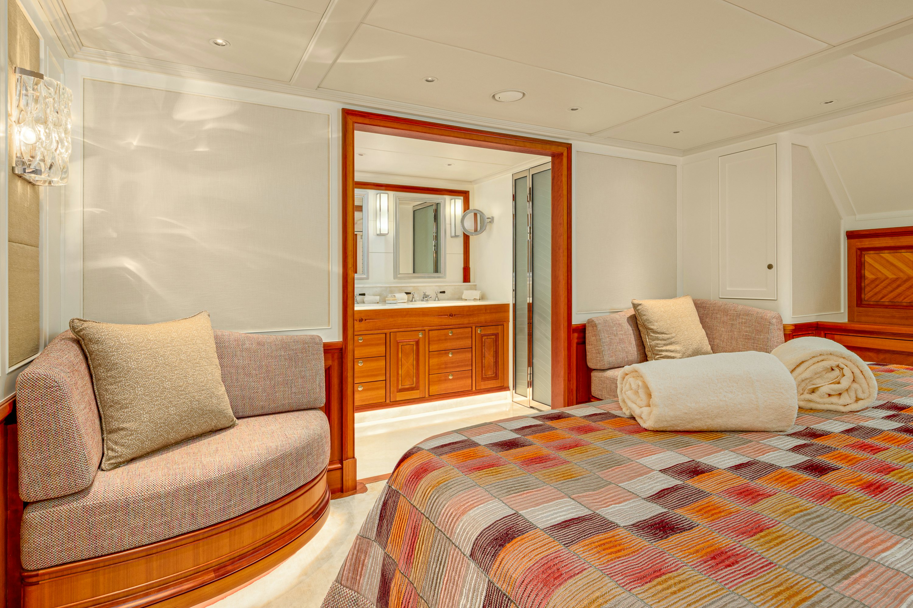 a living room with a bed and a couch aboard FRIVOLOUS Yacht for Sale