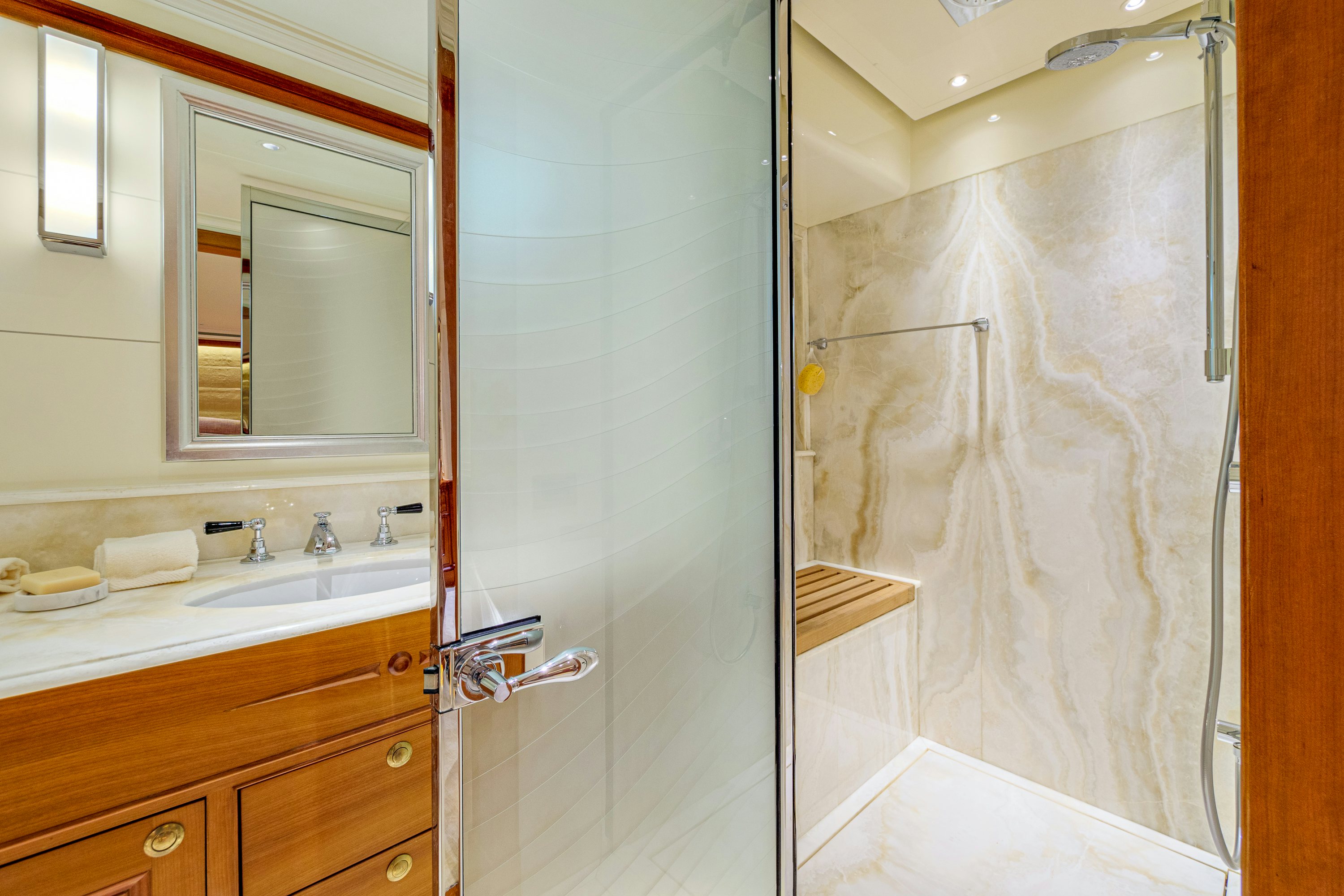 a bathroom with a glass shower aboard FRIVOLOUS Yacht for Sale