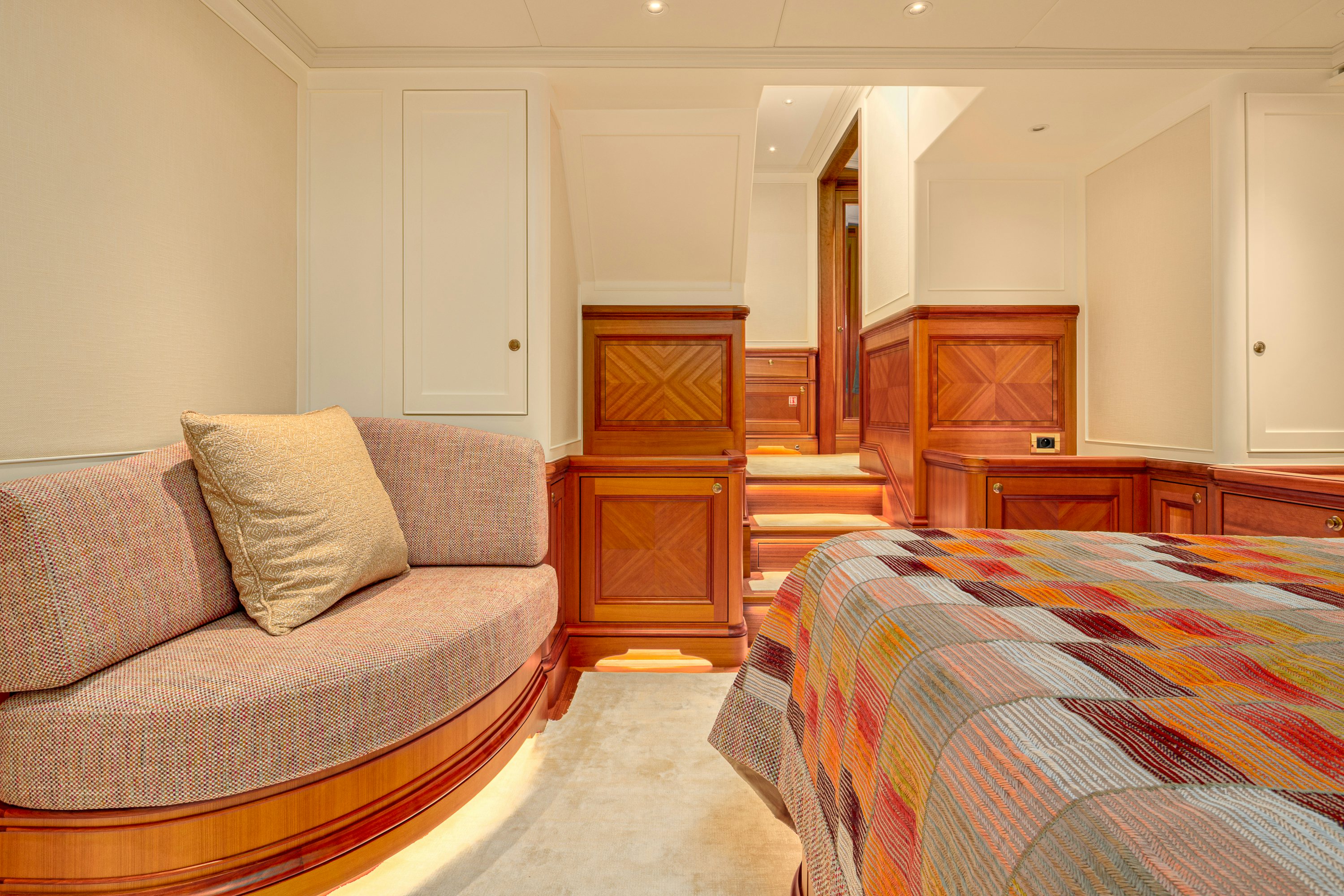 a bedroom with a bed and a couch aboard FRIVOLOUS Yacht for Sale