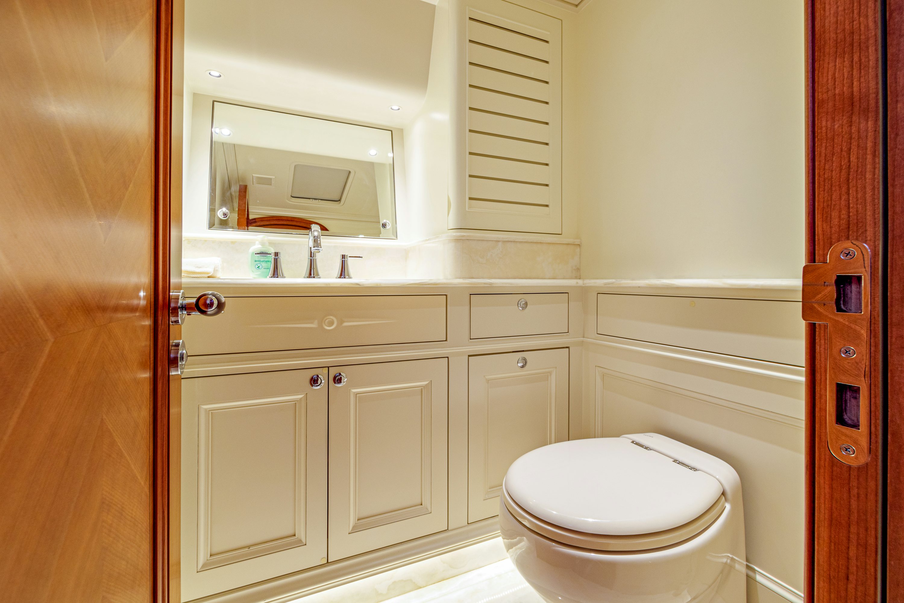 a bathroom with a toilet and a sink aboard FRIVOLOUS Yacht for Sale