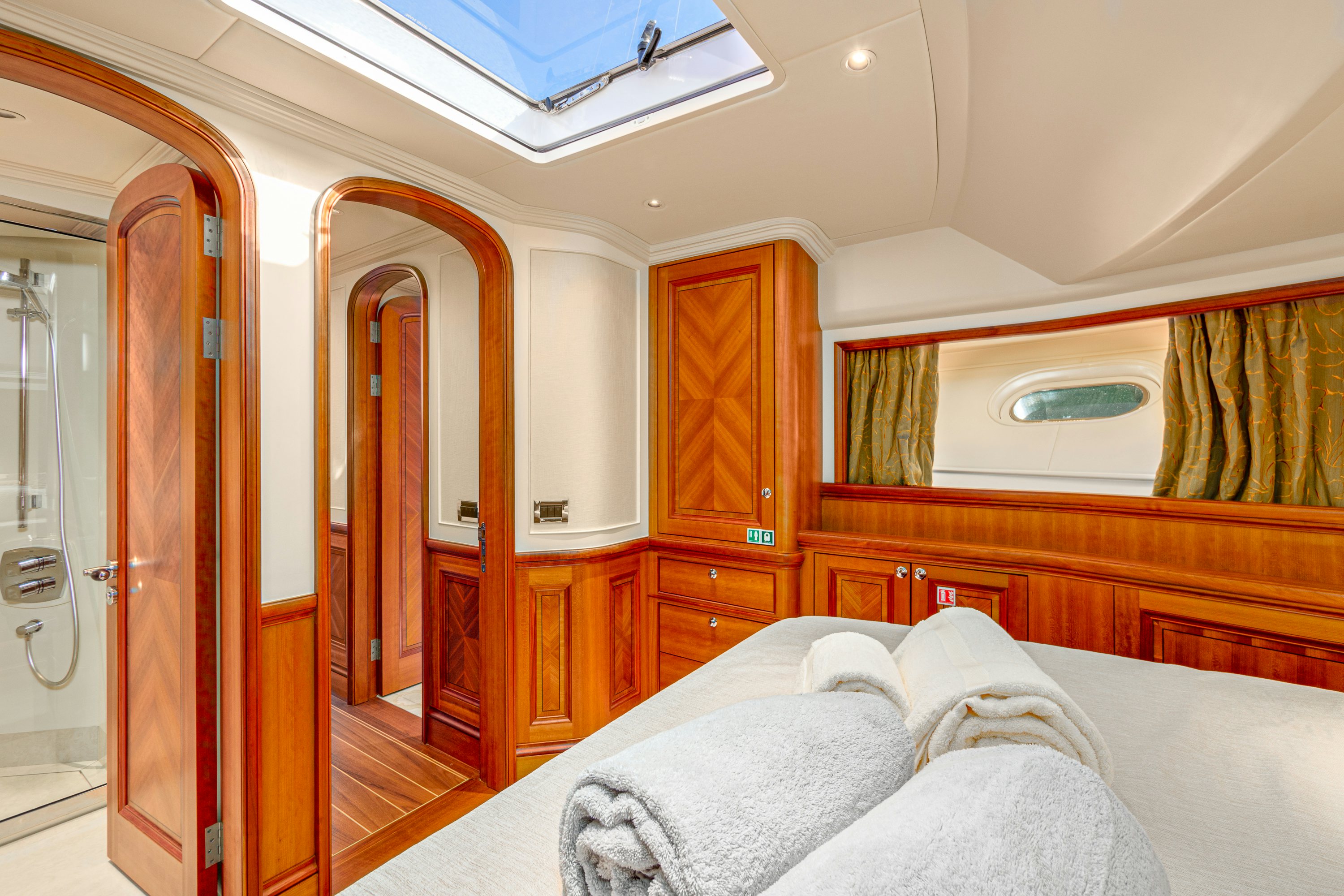 a bedroom with a bed and a closet aboard FRIVOLOUS Yacht for Sale