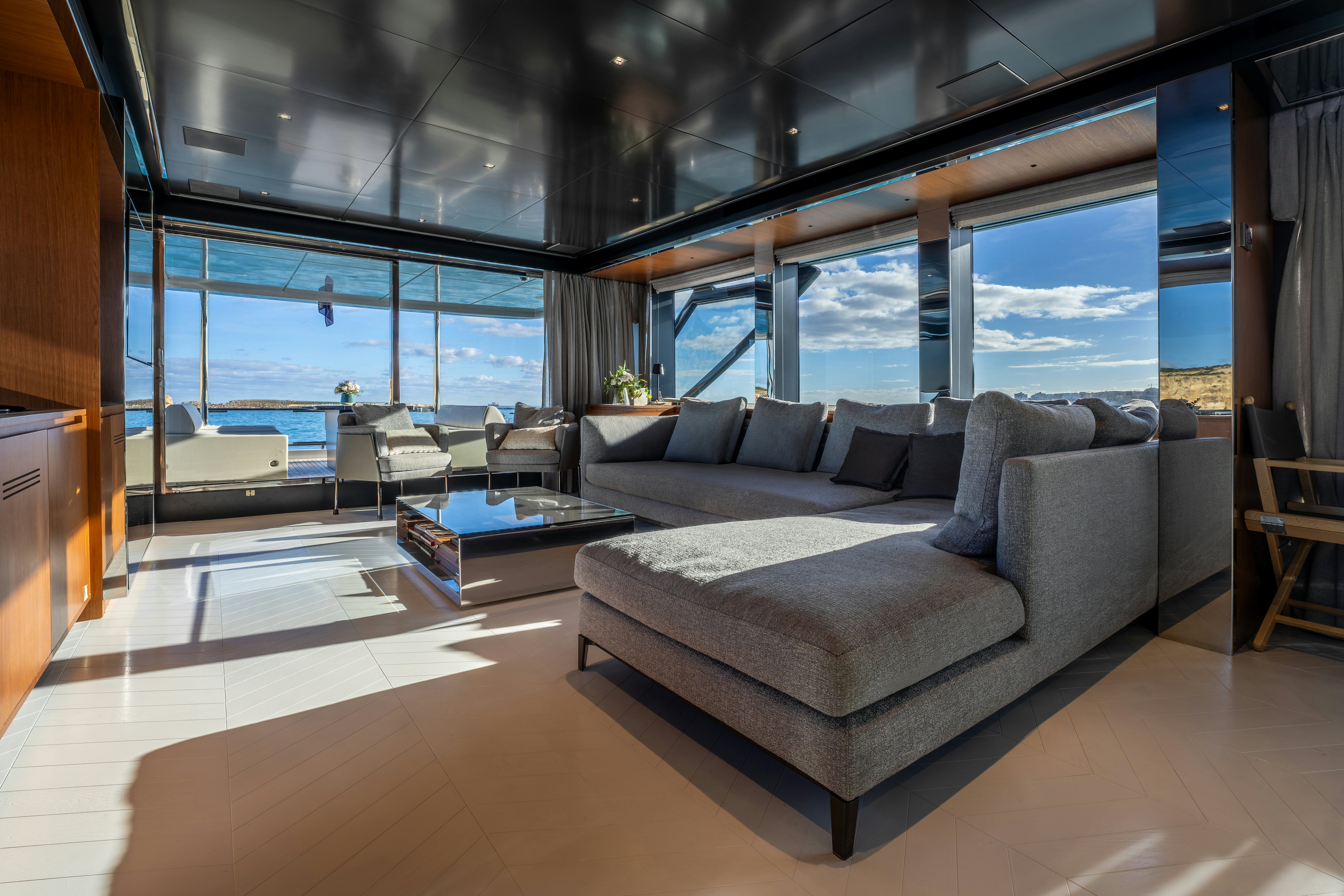 a living room with a large window aboard NOI Yacht for Sale