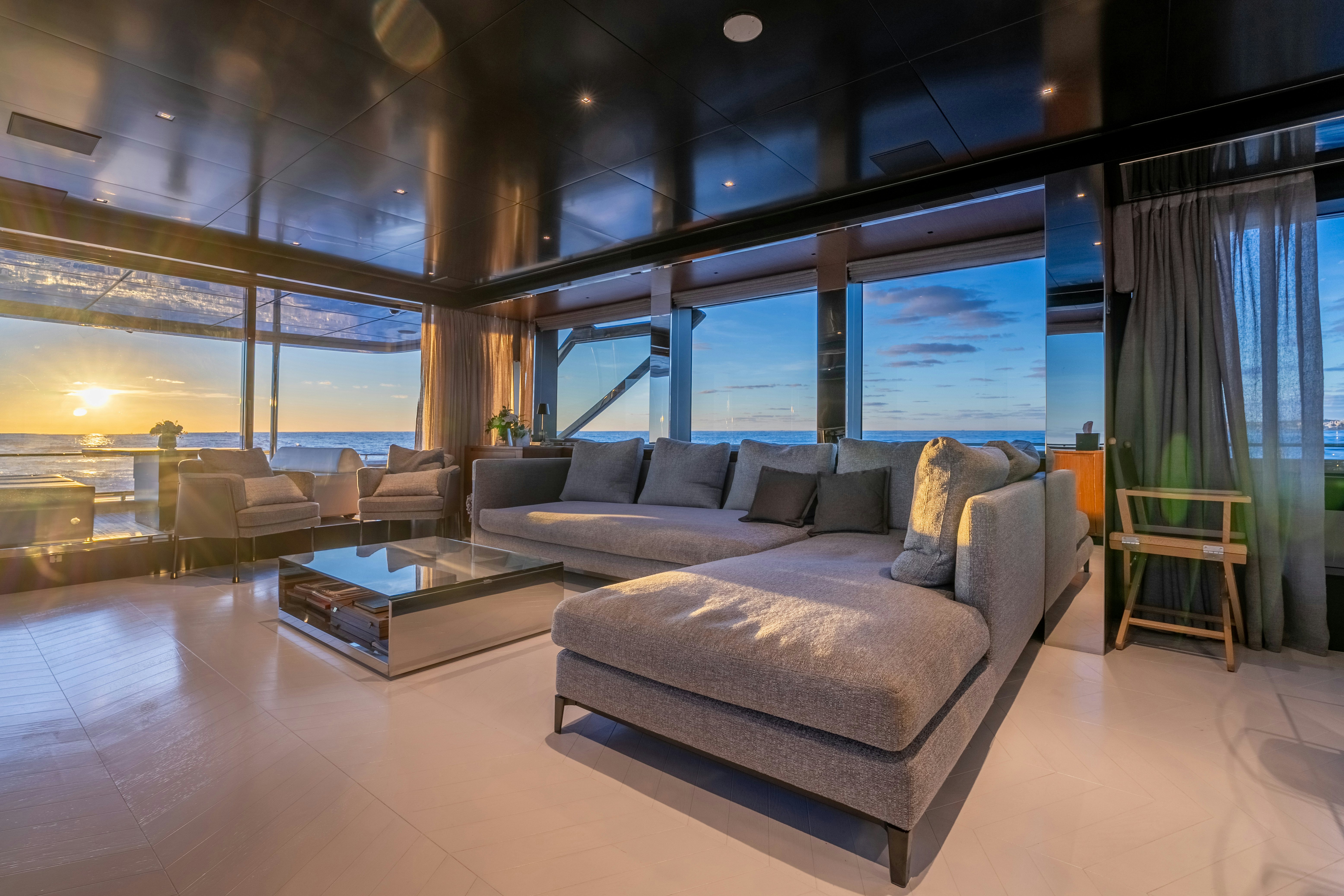 a living room with a couch and a table aboard NOI Yacht for Sale