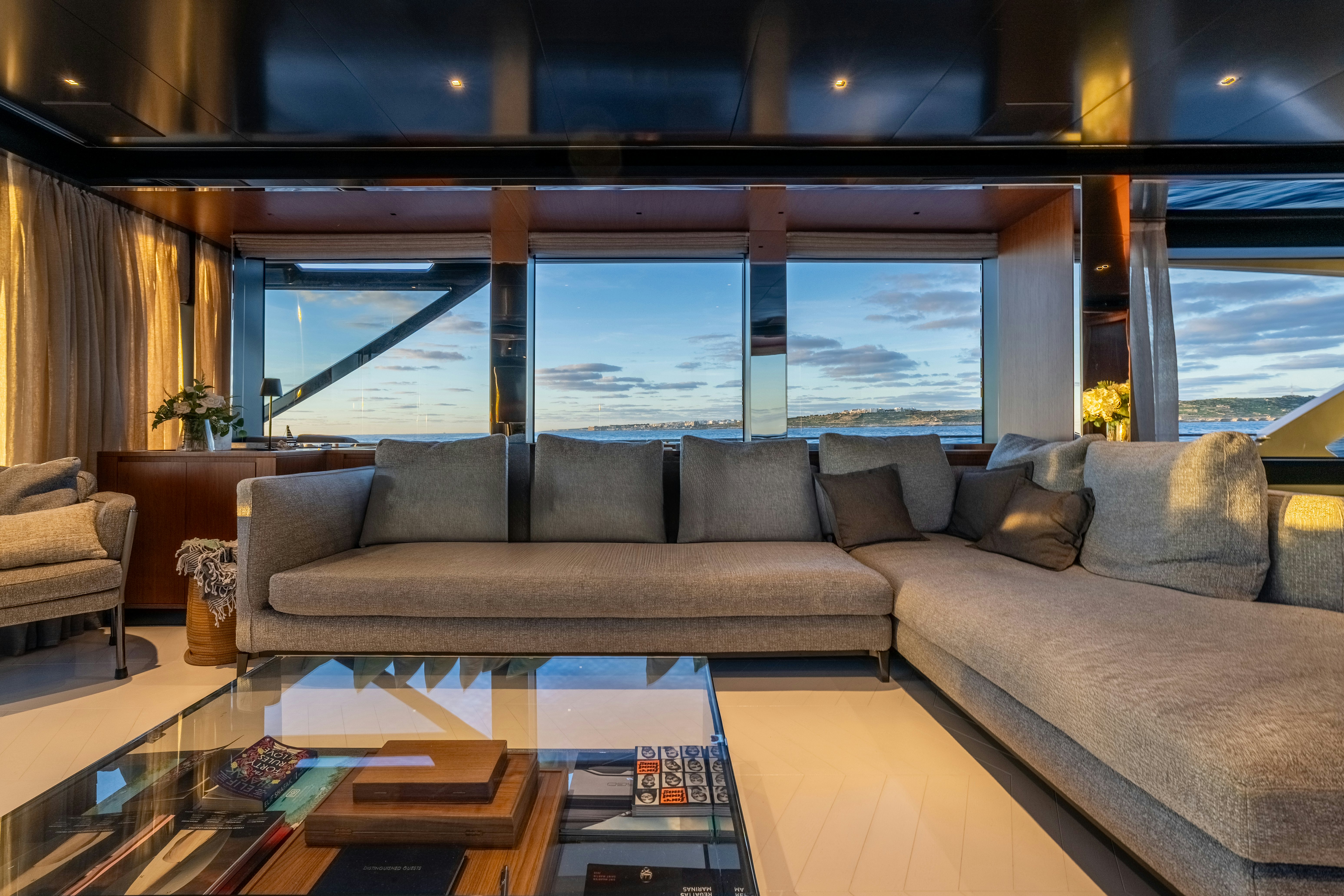 a living room with a large window aboard NOI Yacht for Sale