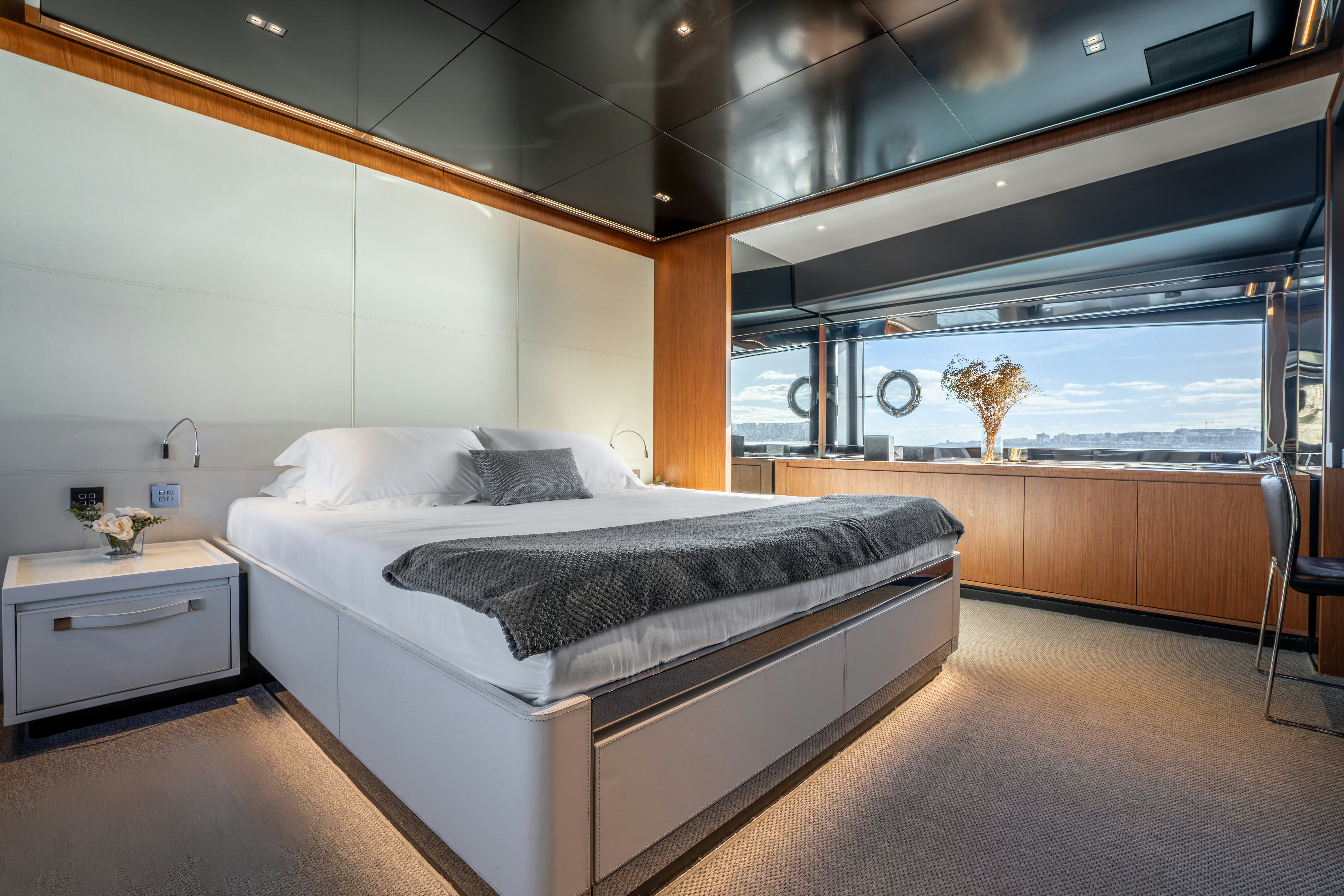 a room with a bed and a window aboard NOI Yacht for Sale
