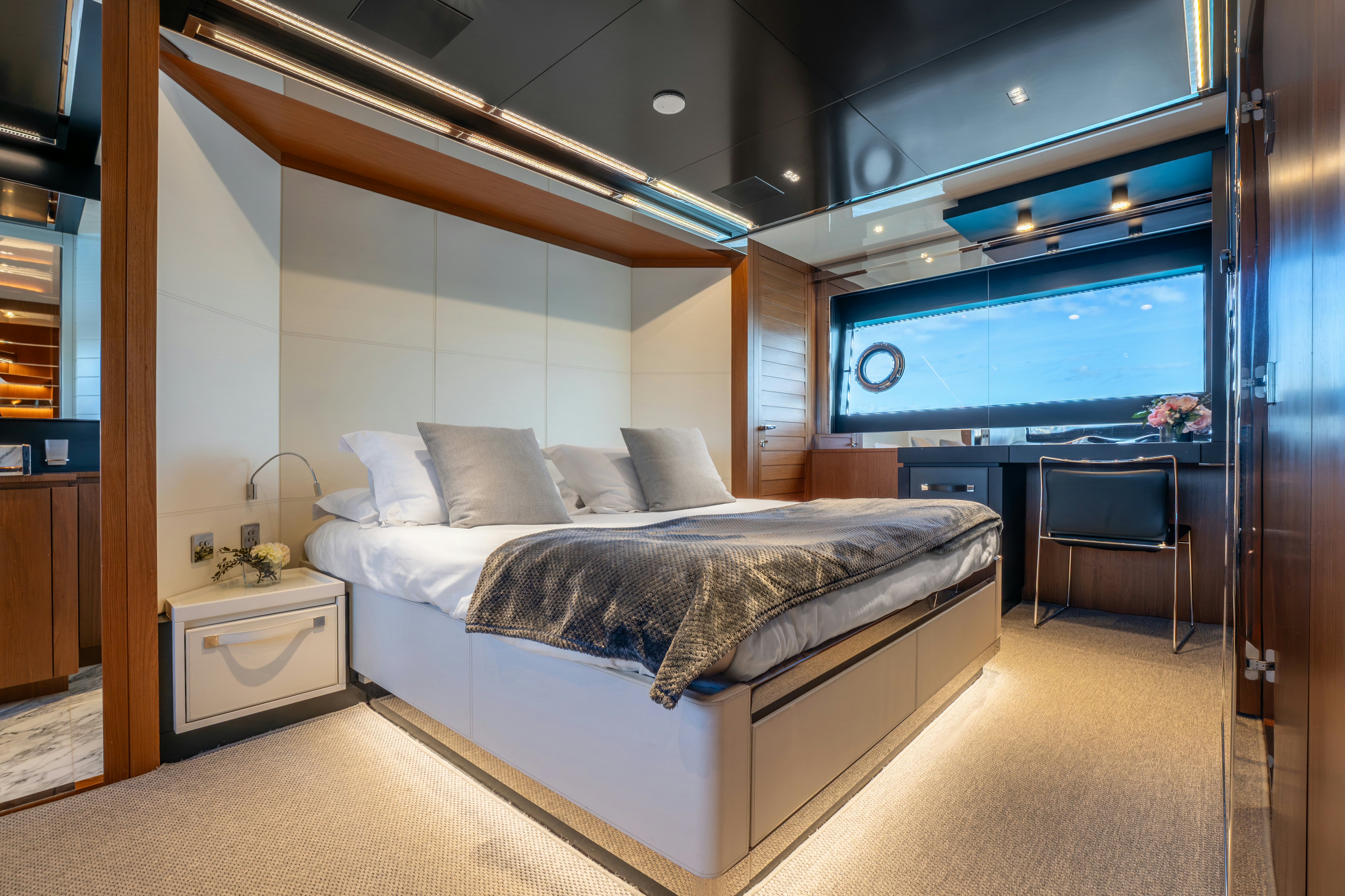 a bedroom with a bed and a desk aboard NOI Yacht for Sale