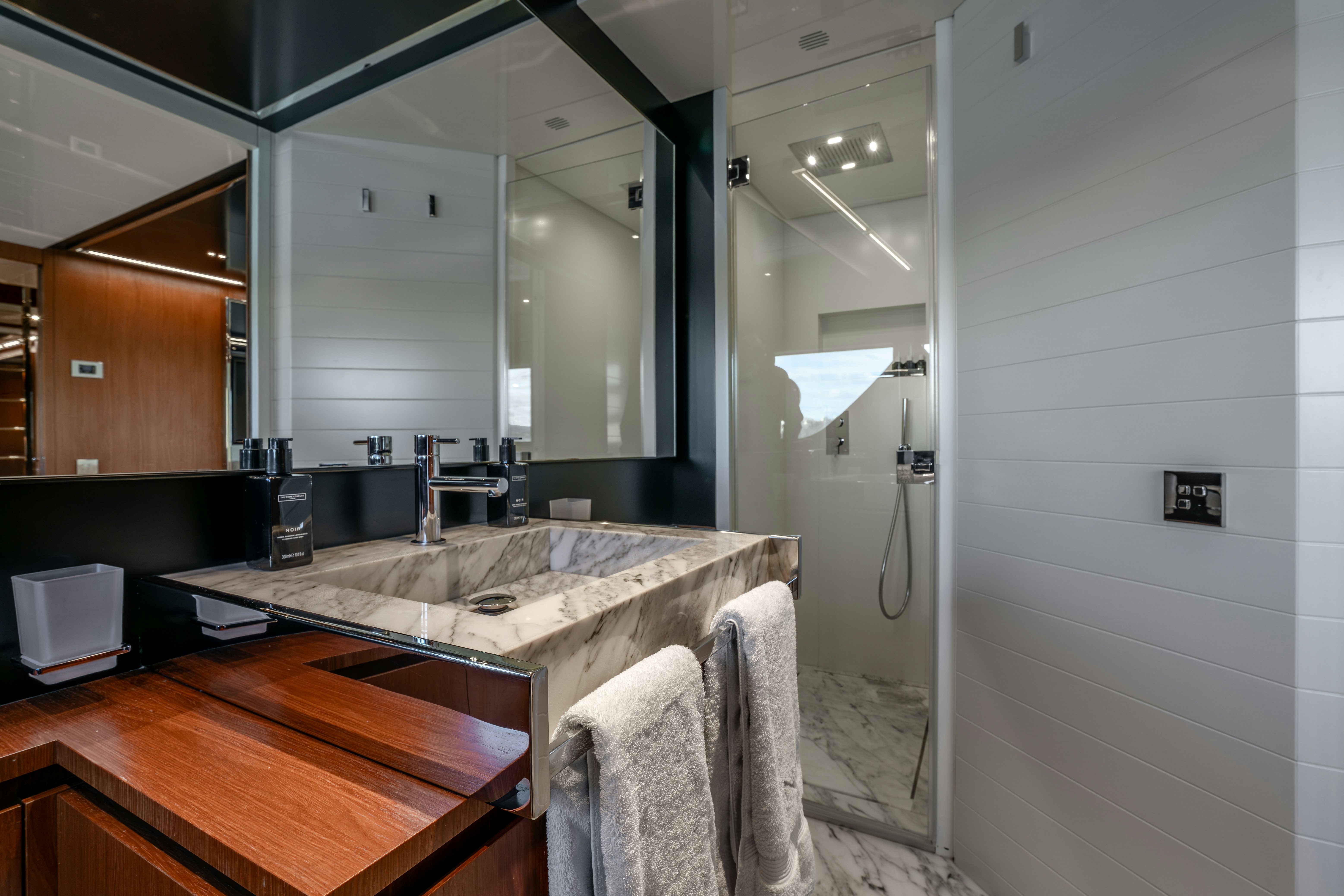 a bathroom with a countertop sink and a mirror aboard NOI Yacht for Sale