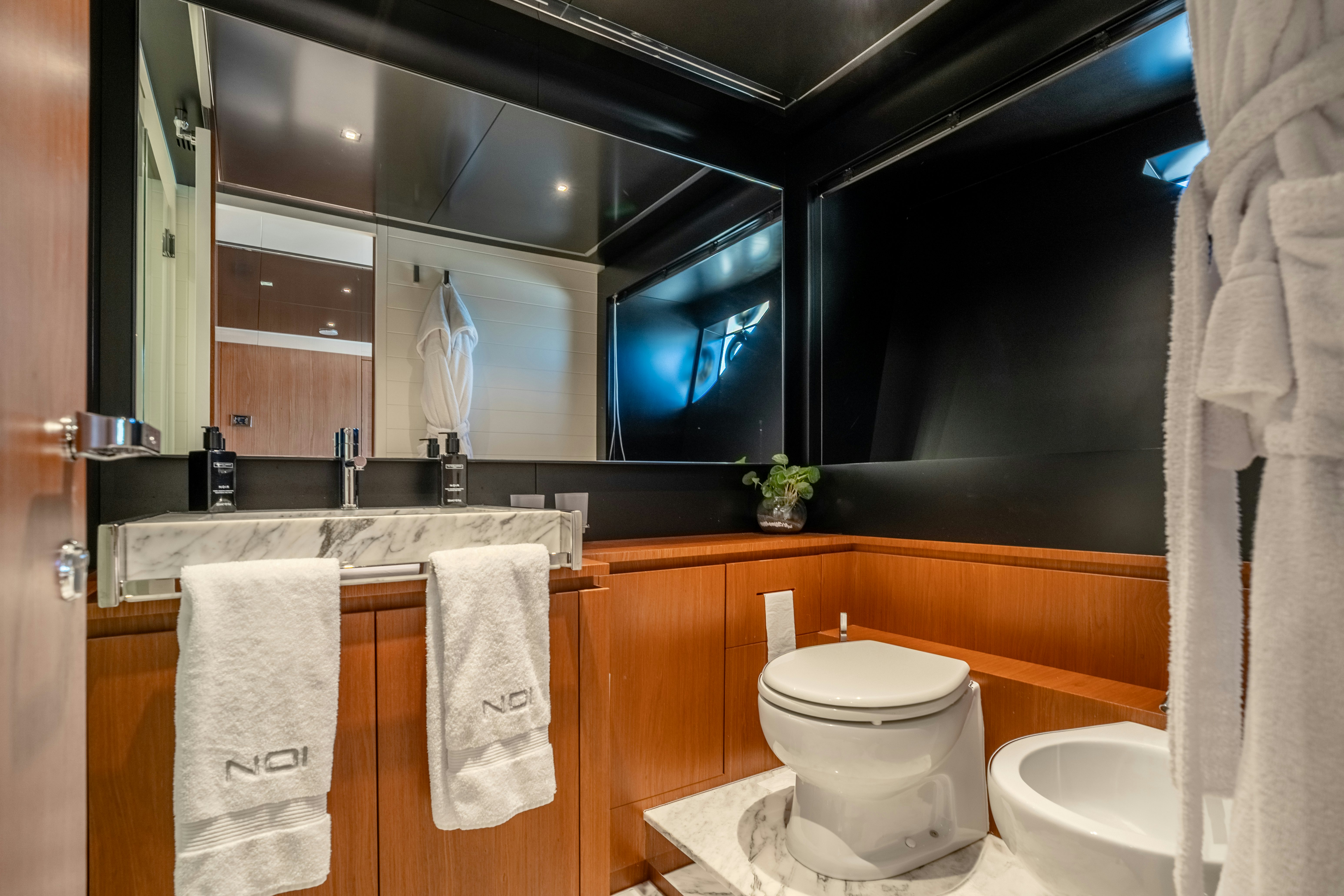 a bathroom with a toilet and a sink aboard NOI Yacht for Sale