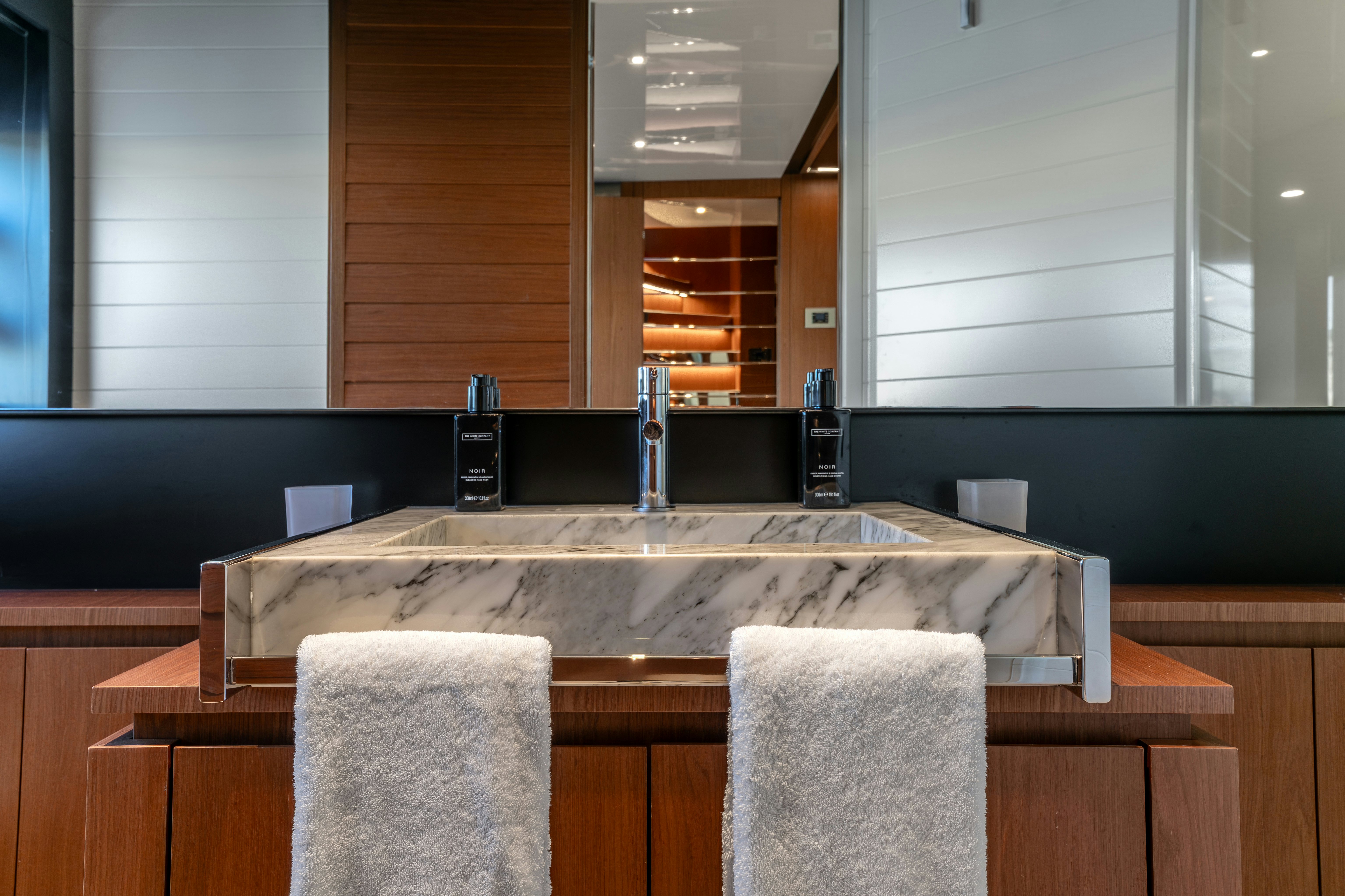 a counter with a sink and a mirror aboard NOI Yacht for Sale