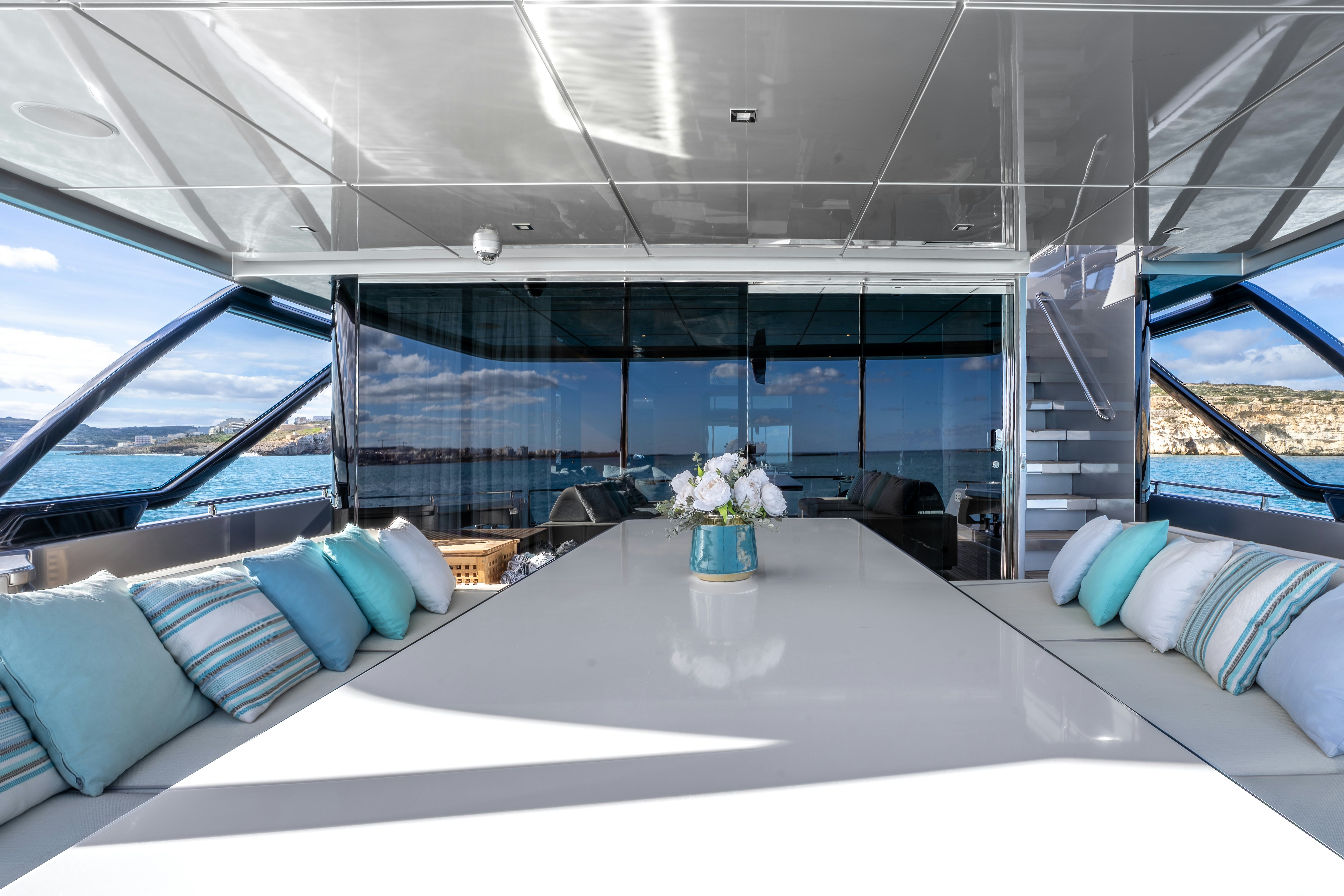 a room with a large bed and a large window aboard NOI Yacht for Sale