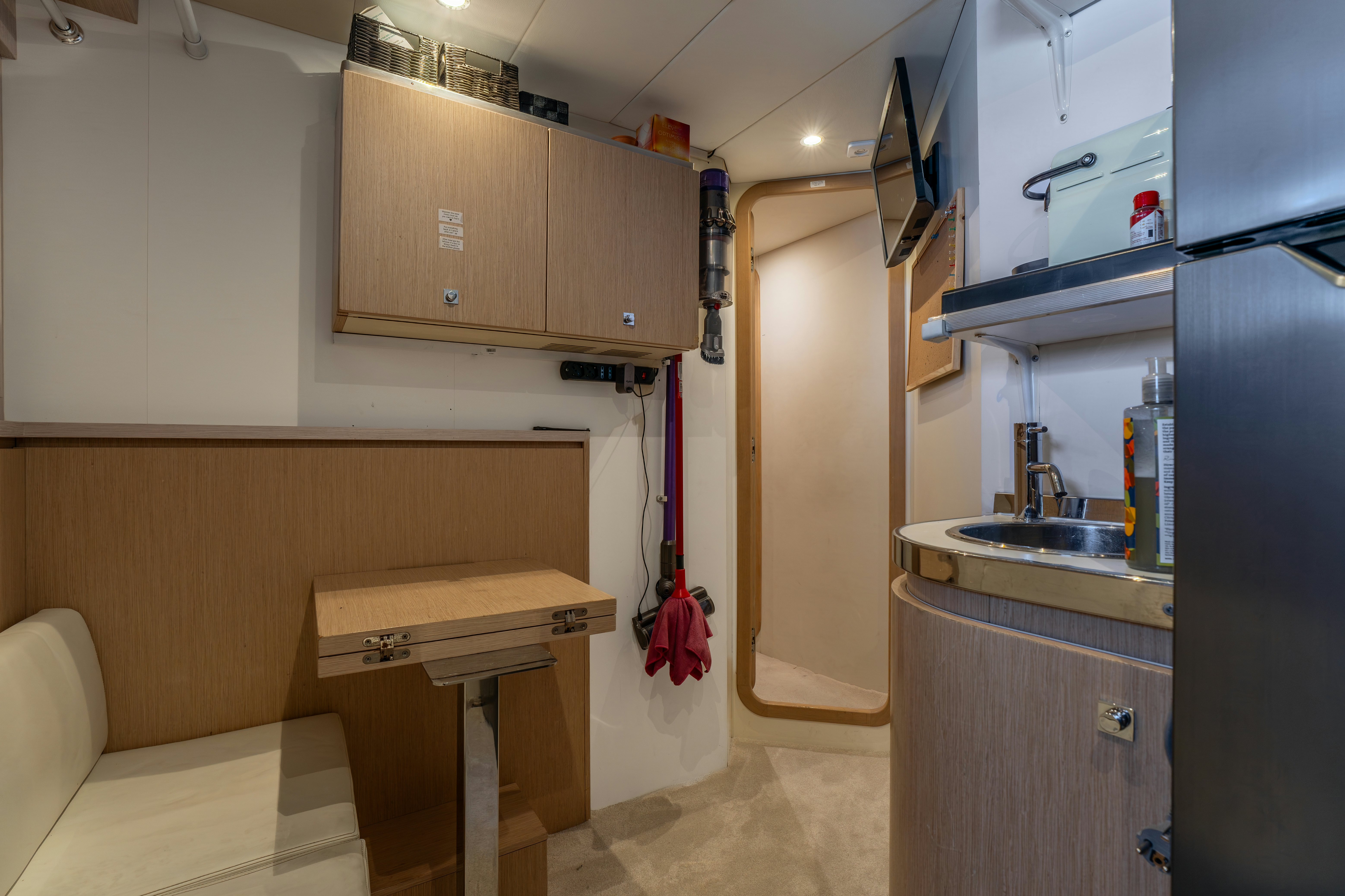 a kitchen with a sink and a refrigerator aboard NOI Yacht for Sale