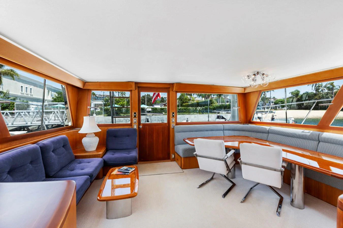 a room with a table chairs and a couch aboard DON JUAN Yacht for Sale