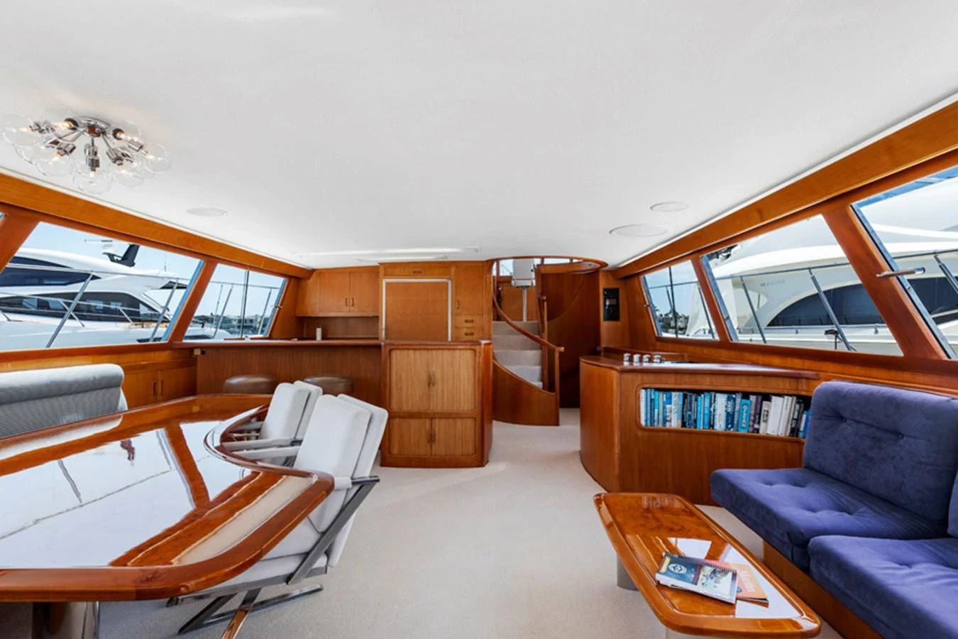 a room with a couch and a table and a bookcase aboard DON JUAN Yacht for Sale