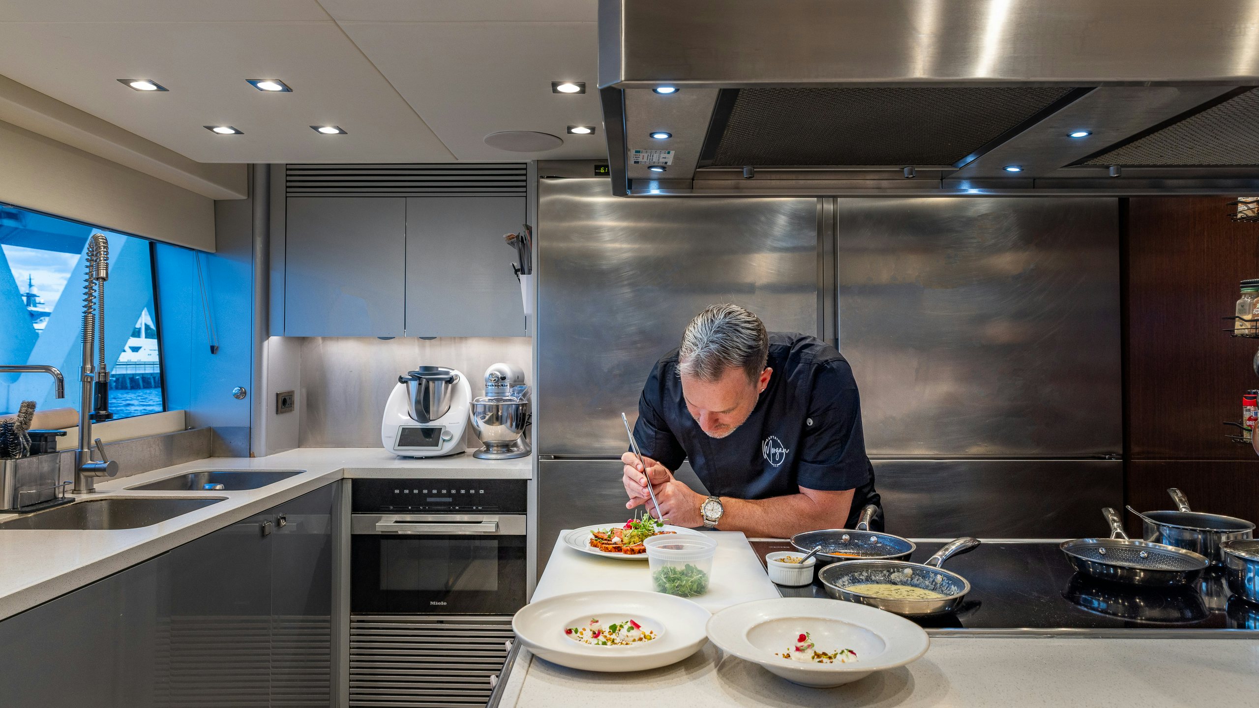 a person in a kitchen preparing food aboard CAPTAIN MORGAN III Yacht for Charter
