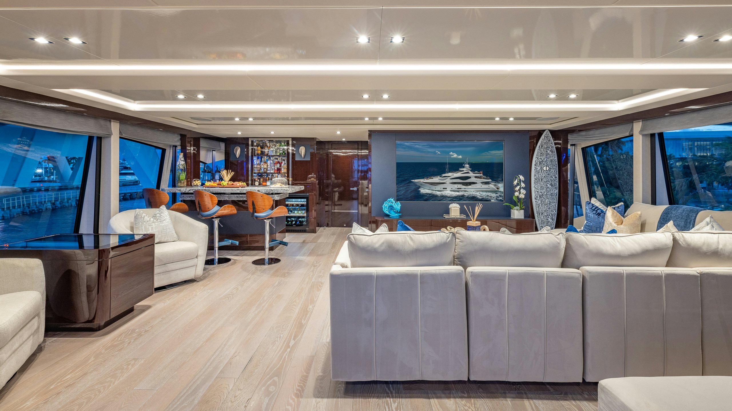 a room with a couch and a table and a tv aboard CAPTAIN MORGAN III Yacht for Charter