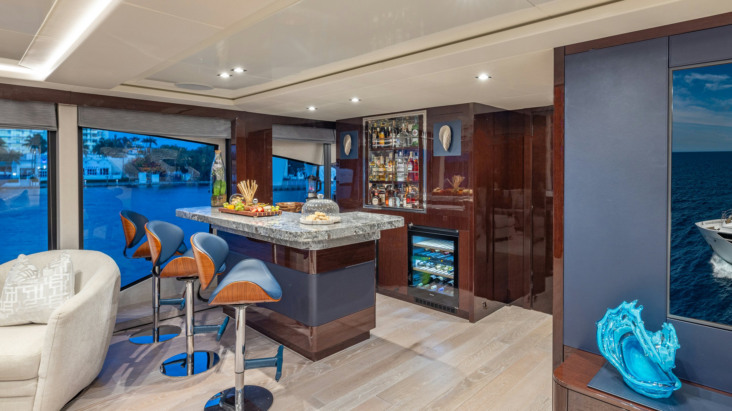 a room with a table chairs and a large window aboard CAPTAIN MORGAN III Yacht for Charter