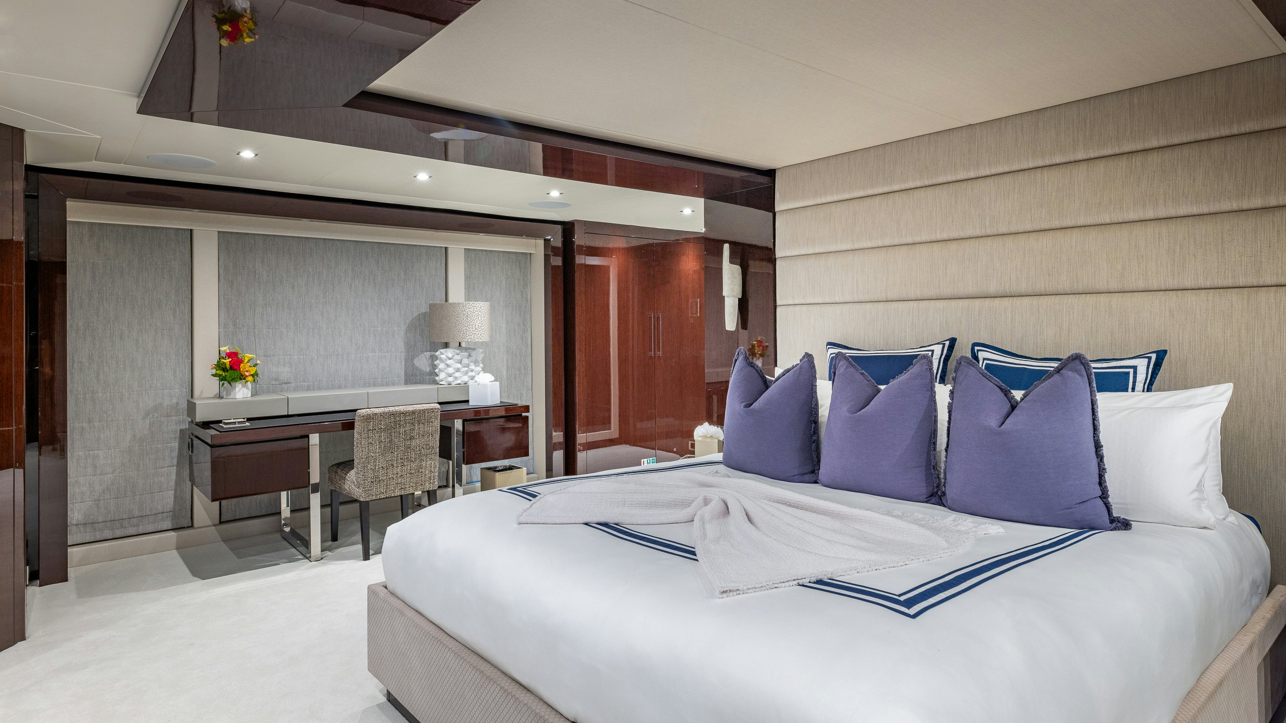 a room with a bed and a desk aboard CAPTAIN MORGAN III Yacht for Charter