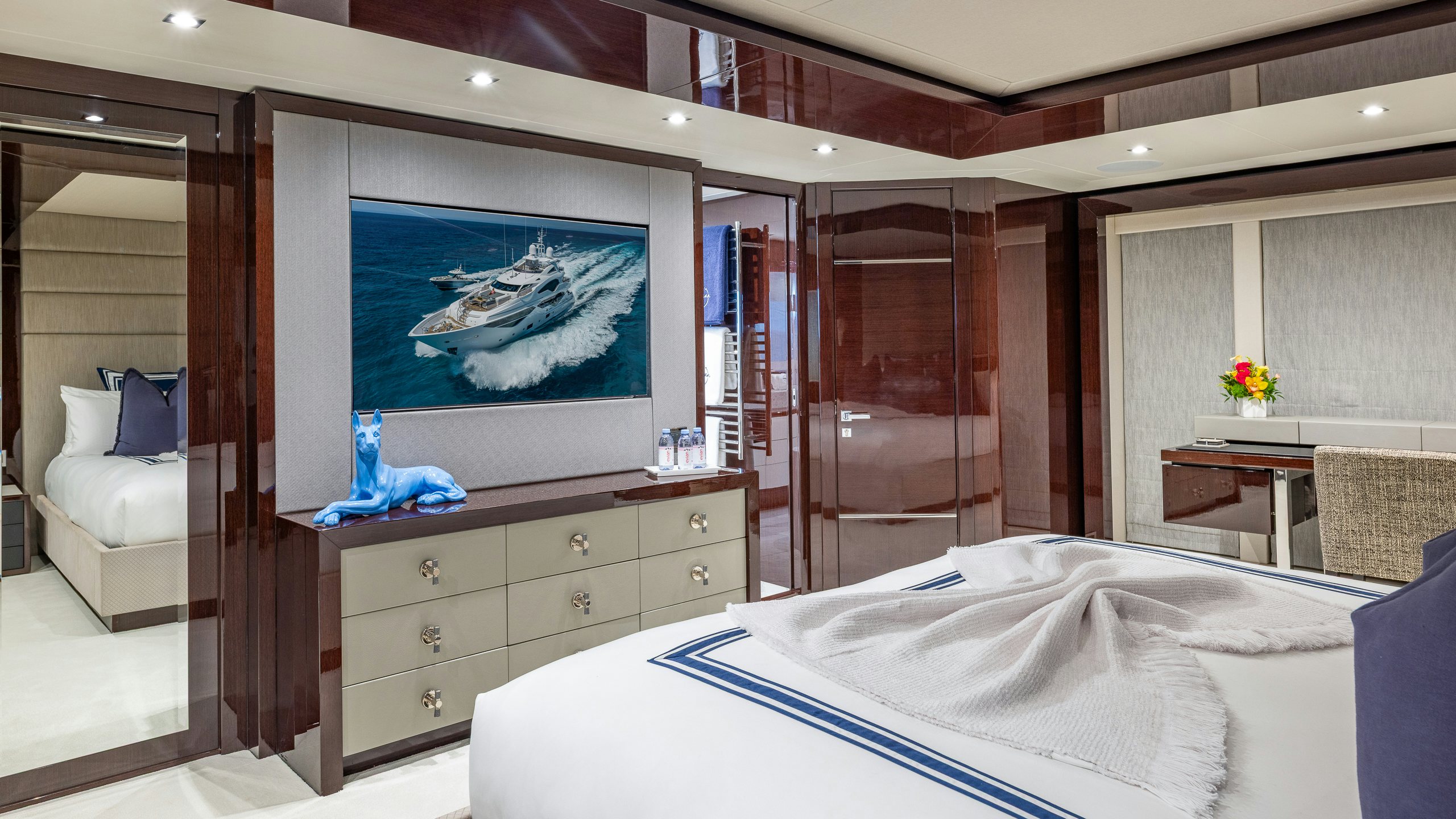 a bedroom with a bed and a television aboard CAPTAIN MORGAN III Yacht for Charter