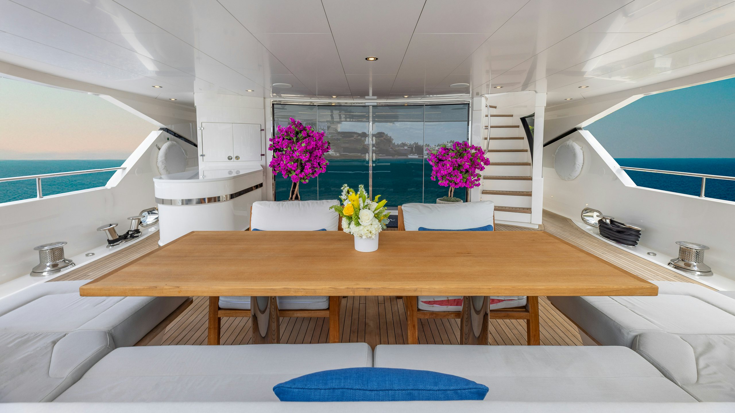 a kitchen with a table and a plant in the middle aboard CAPTAIN MORGAN III Yacht for Charter