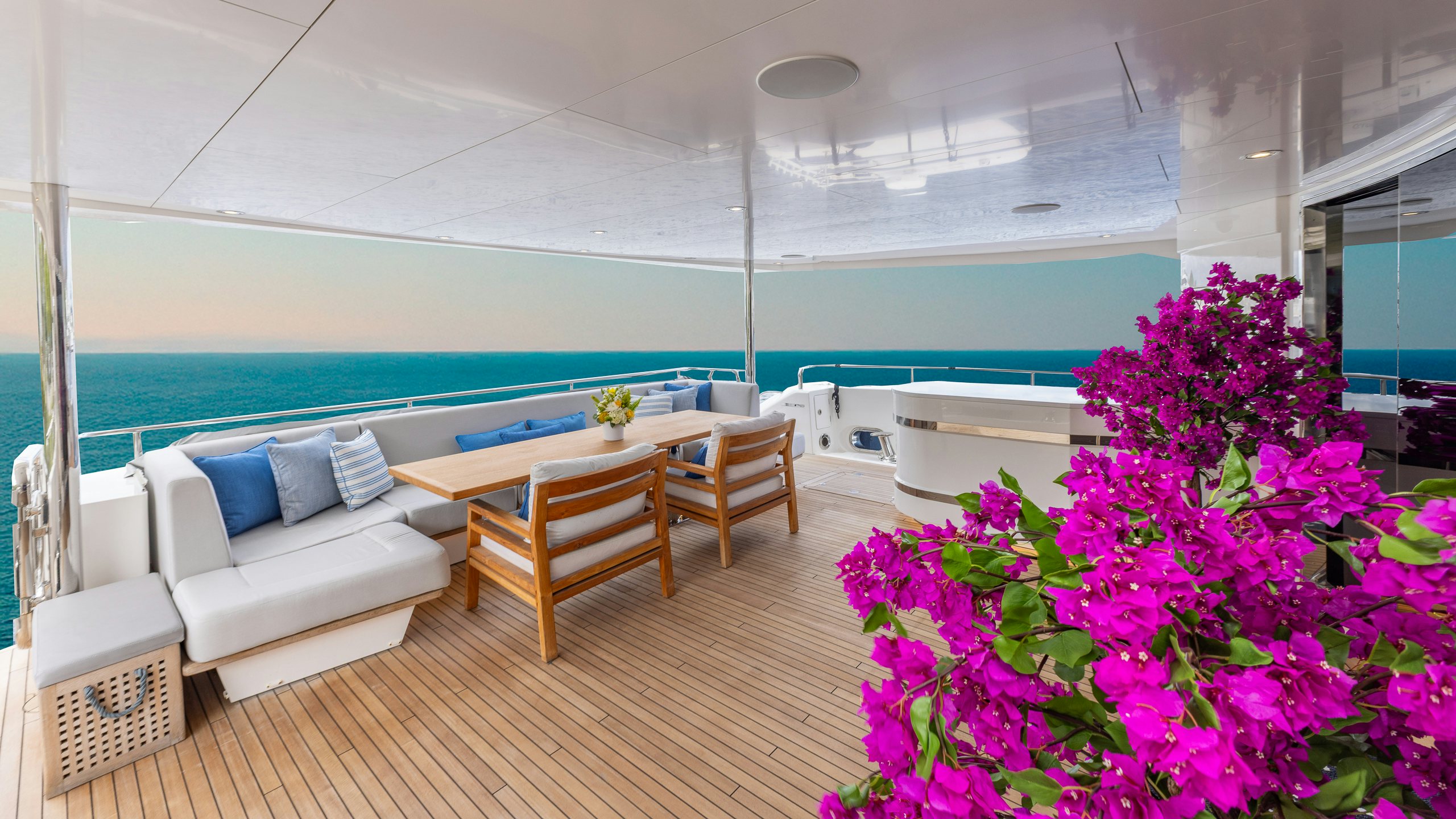 a room with a pool and a table and chairs aboard CAPTAIN MORGAN III Yacht for Charter