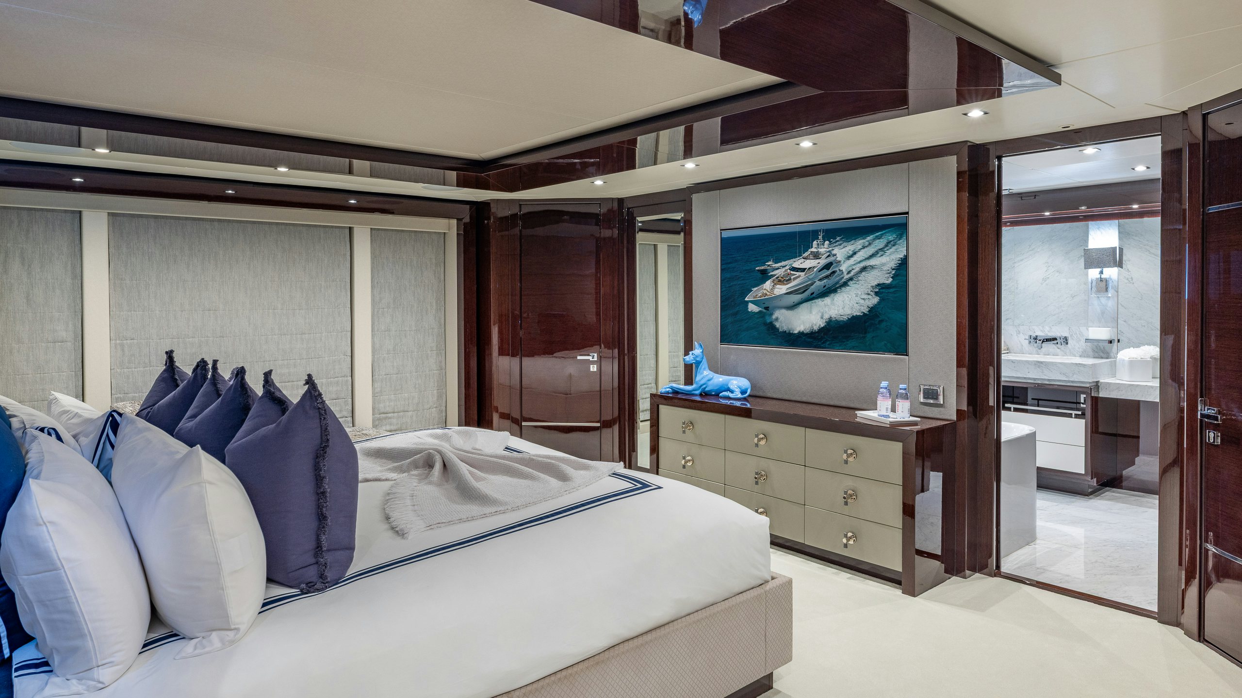 a bedroom with a bed and a television aboard CAPTAIN MORGAN III Yacht for Charter