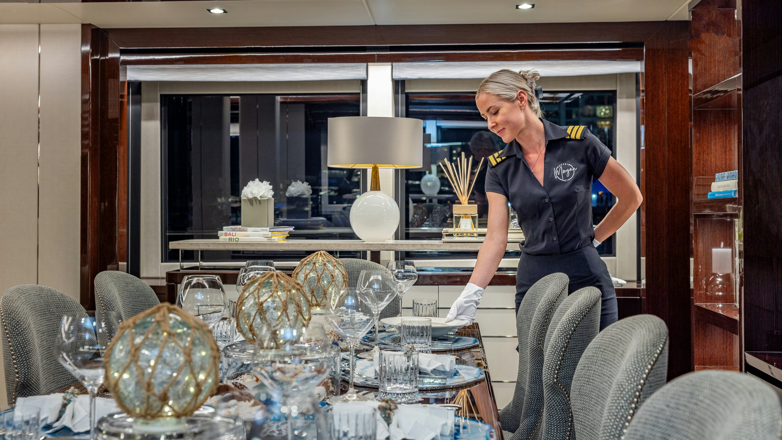 a person pouring wine into a glass aboard CAPTAIN MORGAN III Yacht for Charter