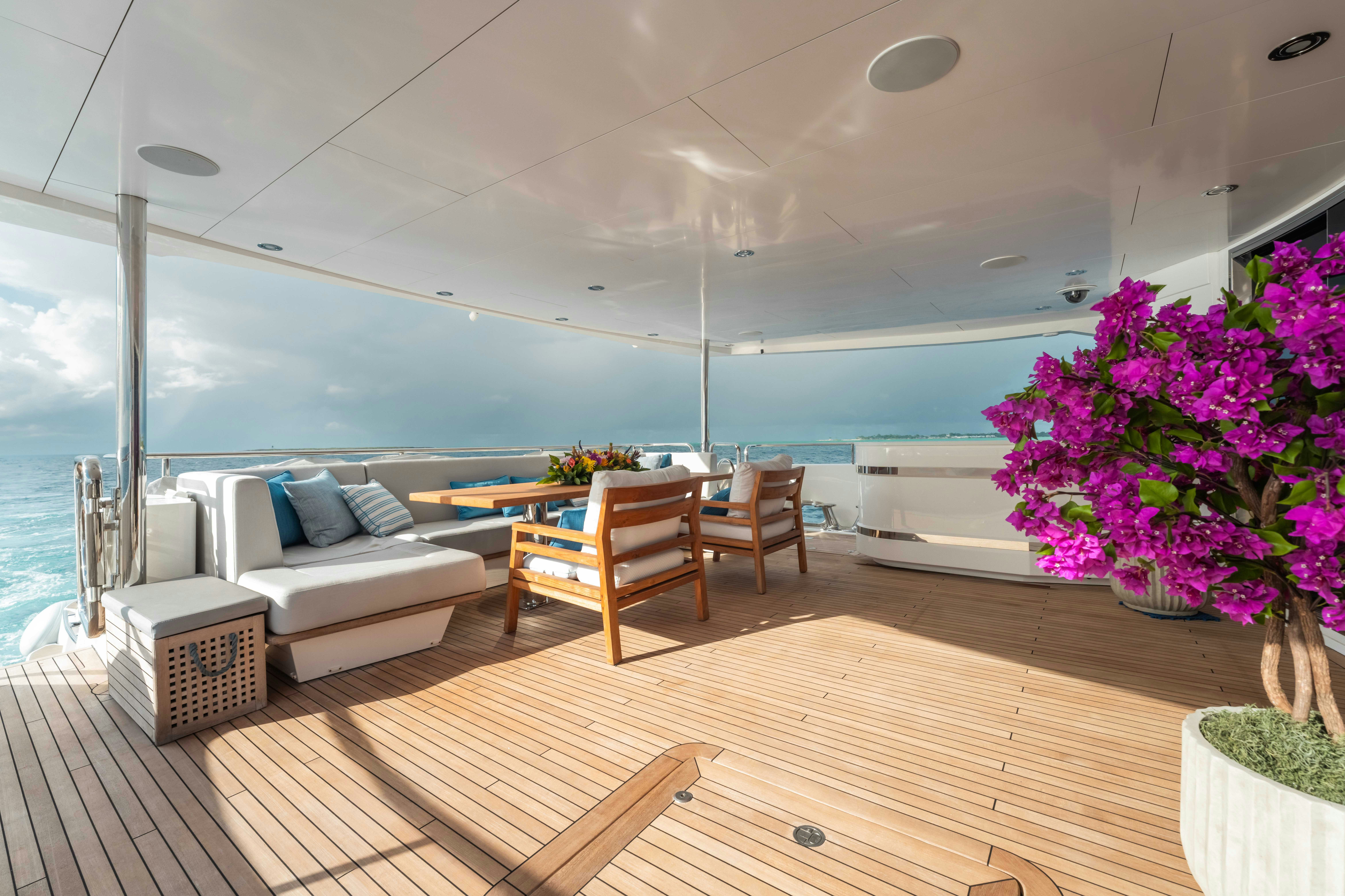 a room with a couch and a table and chairs aboard CAPTAIN MORGAN III Yacht for Charter