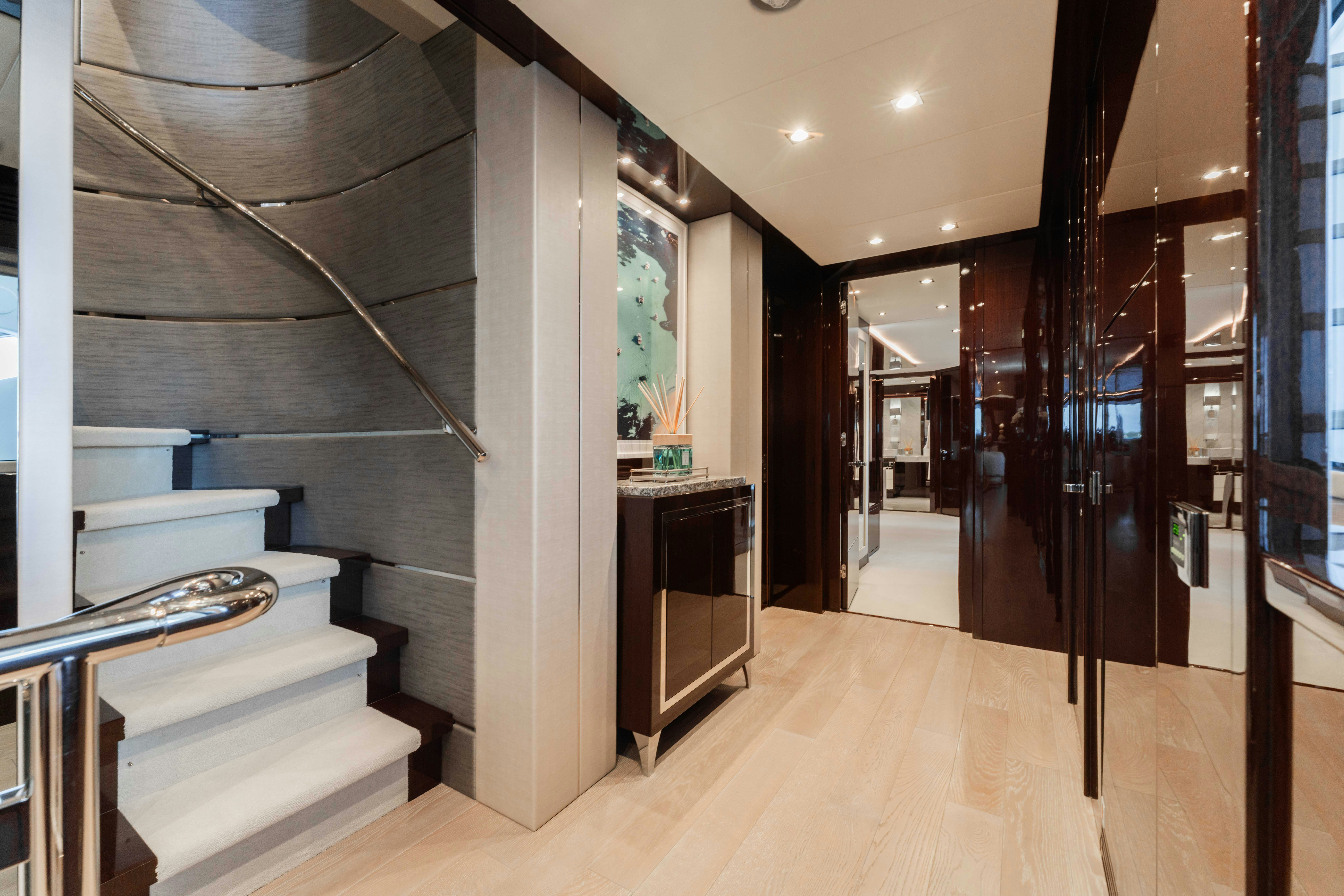 a room with a wood floor and a staircase aboard CAPTAIN MORGAN III Yacht for Charter