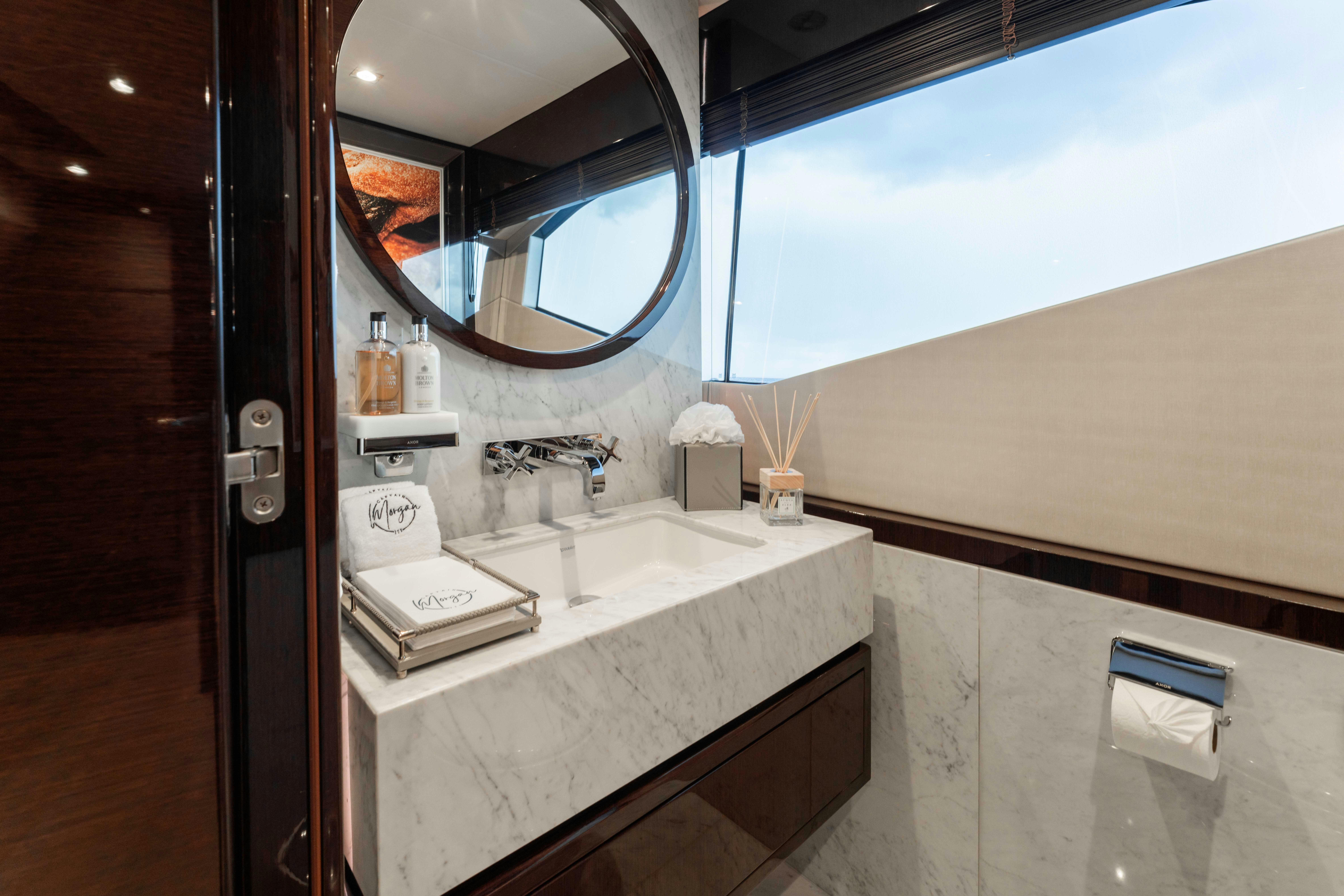 a bathroom with a large mirror aboard CAPTAIN MORGAN III Yacht for Charter