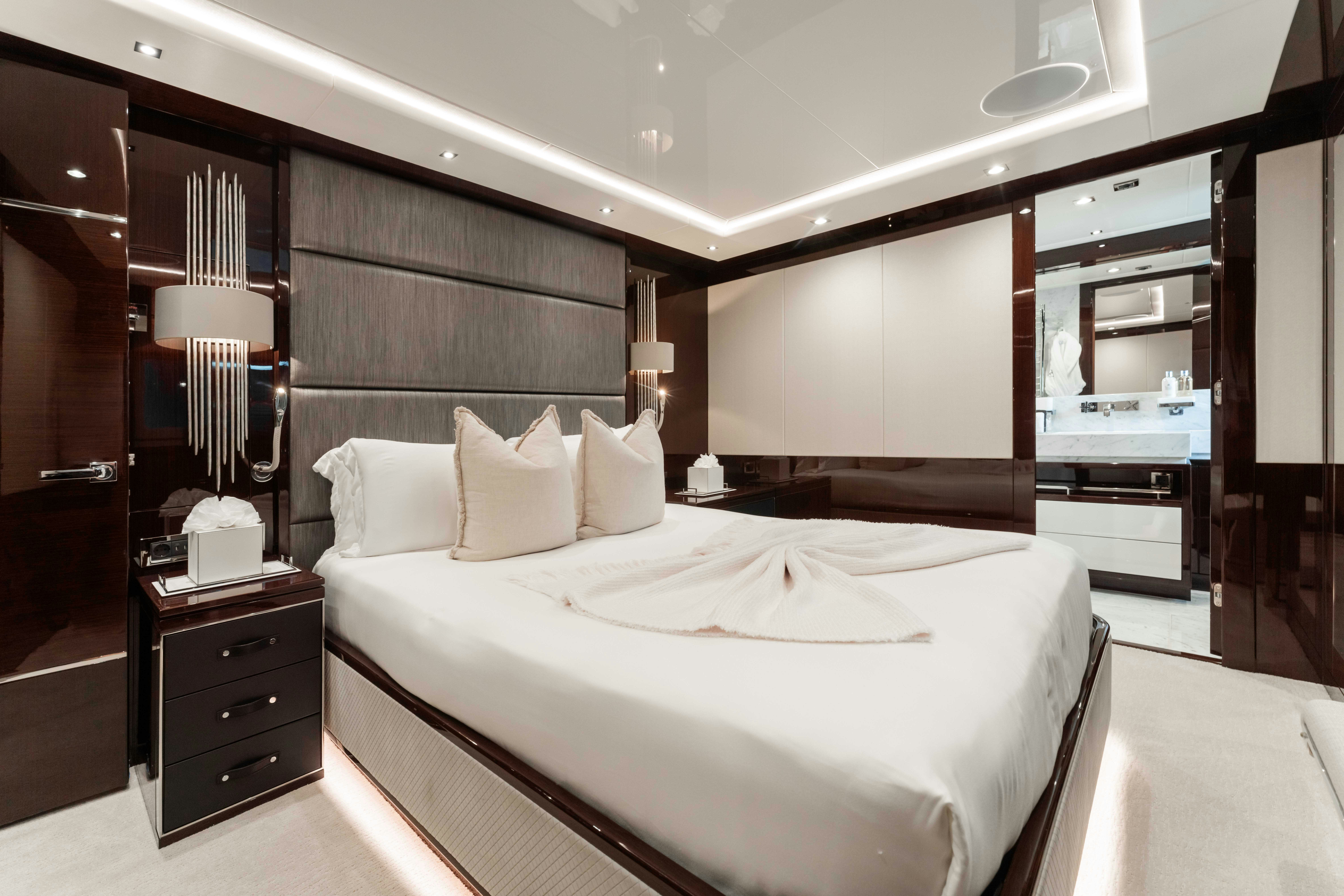 a room with a bed and a mirror aboard CAPTAIN MORGAN III Yacht for Charter